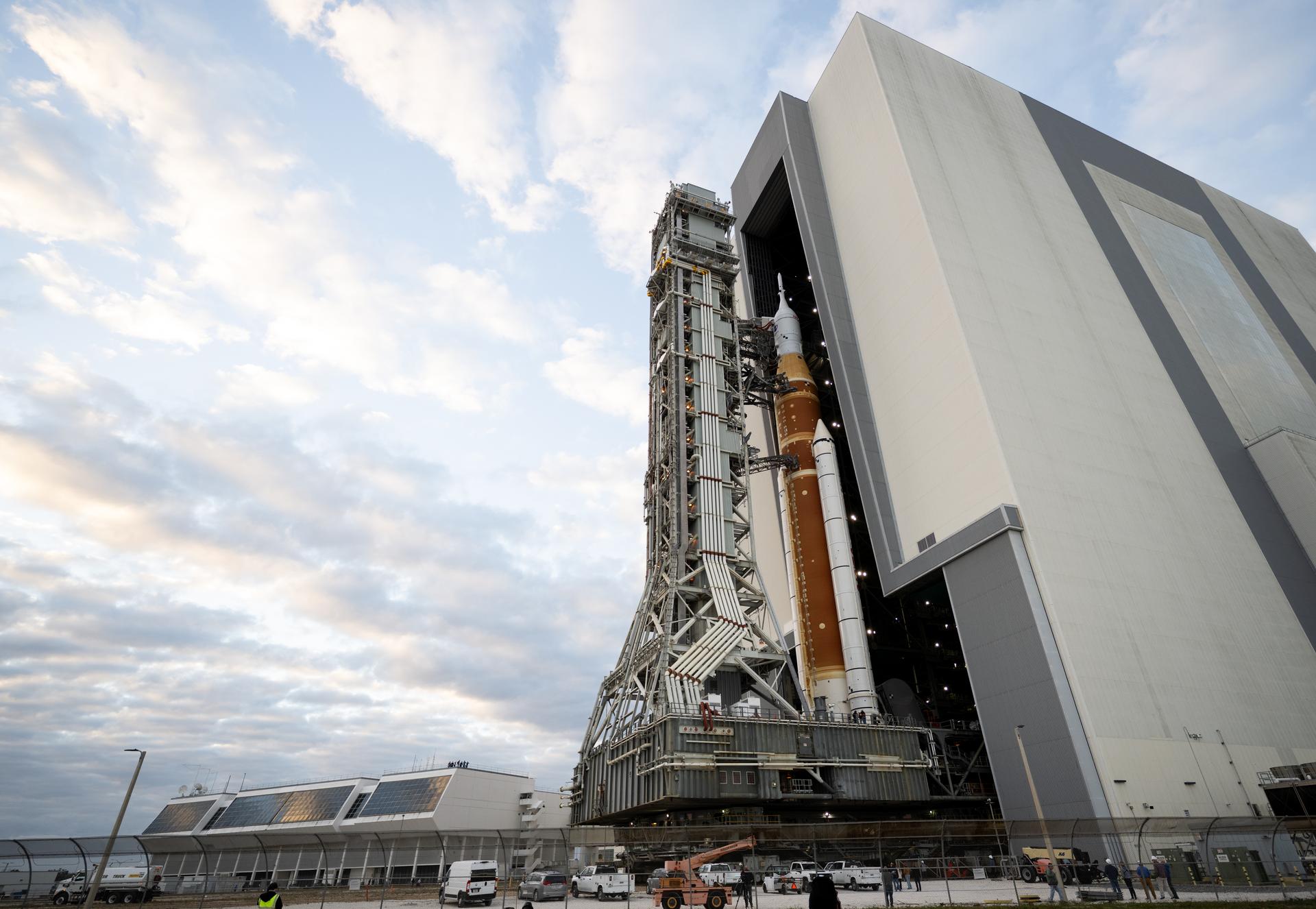 NASA’s Space Launch System (SLS) rocket and Orion spacecraft, secured to the mobile launcher, is seen as it rolls out of the Vehicle Assembly Building to Launch Pad 39B, Sat, Jan. 17, 2026, at NASA’s Kennedy Space Center in Florida. NASA’s Artemis II test flight will take Commander Reid Wiseman, Pilot Victor Glover, and Mission Specialist Christina Koch from NASA, and Mission Specialist Jeremy Hansen from the CSA (Canadian Space Agency), around the Moon and back to Earth no later than no later than April 2026. Photo Credit: (NASA/Joel Kowsky)