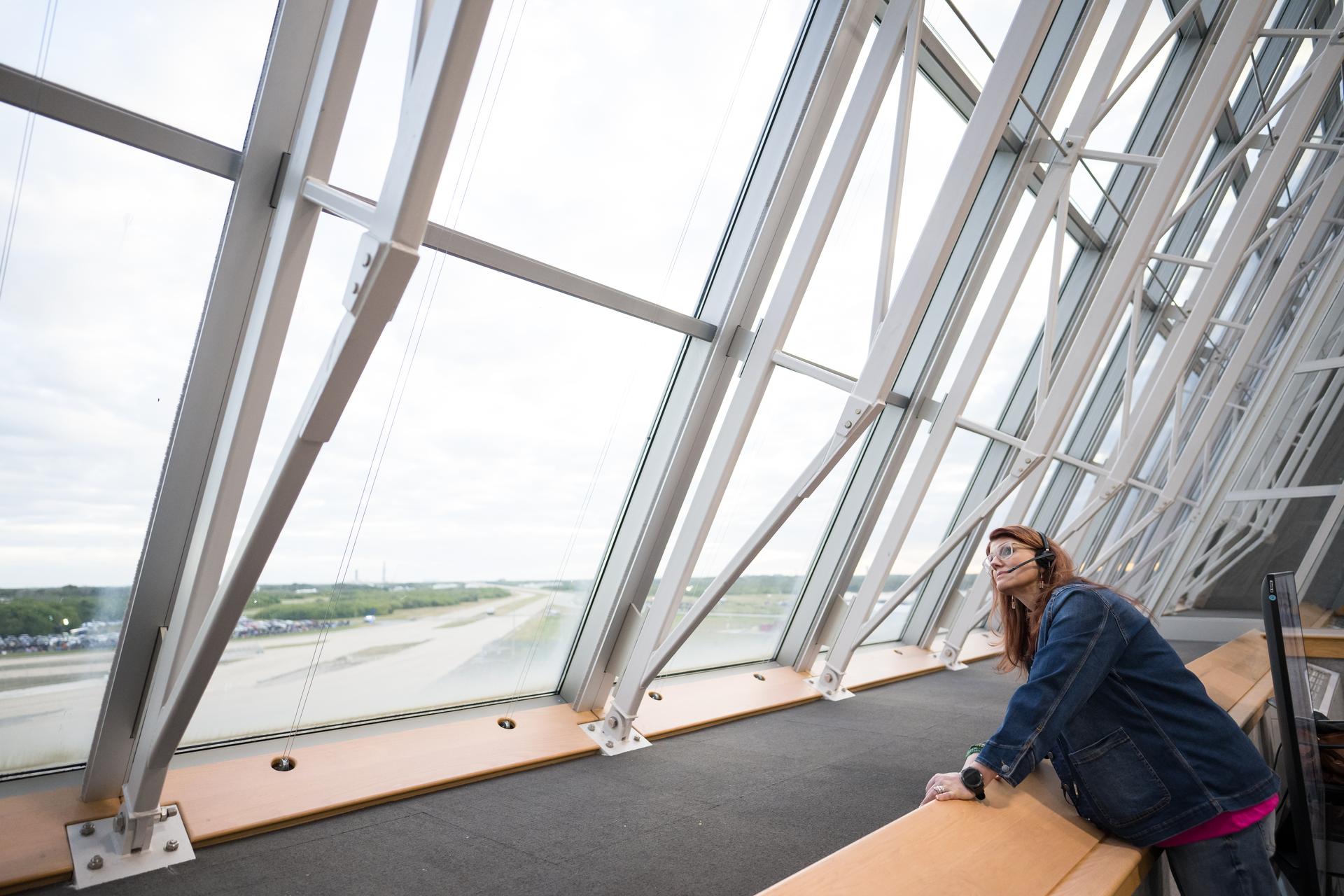 Charlie Blackwell-Thompson, Artemis II launch director at NASA's Kennedy Space Center looks out the window while on console in Firing Room One of the Rocco A. Petrone Launch Control Center as NASA’s Artemis II Space Launch System (SLS) rocket and Orion spacecraft, secured to the mobile launcher, roll out of High Bay 3 of the Vehicle Assembly Building to Launch Complex 39B, Saturday, Jan. 17, 2026, at NASA’s Kennedy Space Center in Florida. NASA’s Artemis II test flight will take Commander Reid Wiseman, Pilot Victor Glover, and Mission Specialist Christina Koch from NASA, and Mission Specialist Jeremy Hansen from the CSA (Canadian Space Agency), around the Moon and back to Earth no later than April 2026. Photo Credit: (NASA/Aubrey Gemignani)