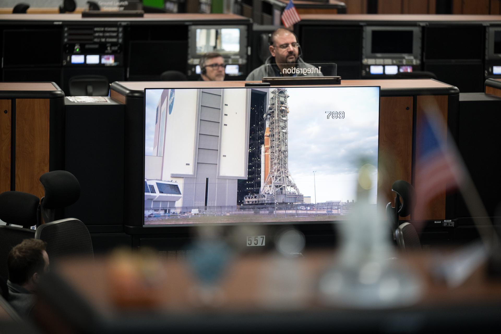 Members of the Artemis II launch team are seen on console in Firing Room One of the Rocco A. Petrone Launch Control Center as NASA’s Artemis II Space Launch System (SLS) rocket and Orion spacecraft, secured to the mobile launcher, roll out of High Bay 3 of the Vehicle Assembly Building to Launch Complex 39B, Saturday, Jan. 17, 2026, at NASA’s Kennedy Space Center in Florida. NASA’s Artemis II test flight will take Commander Reid Wiseman, Pilot Victor Glover, and Mission Specialist Christina Koch from NASA, and Mission Specialist Jeremy Hansen from the CSA (Canadian Space Agency), around the Moon and back to Earth no later than April 2026. Photo Credit: (NASA/Aubrey Gemignani)