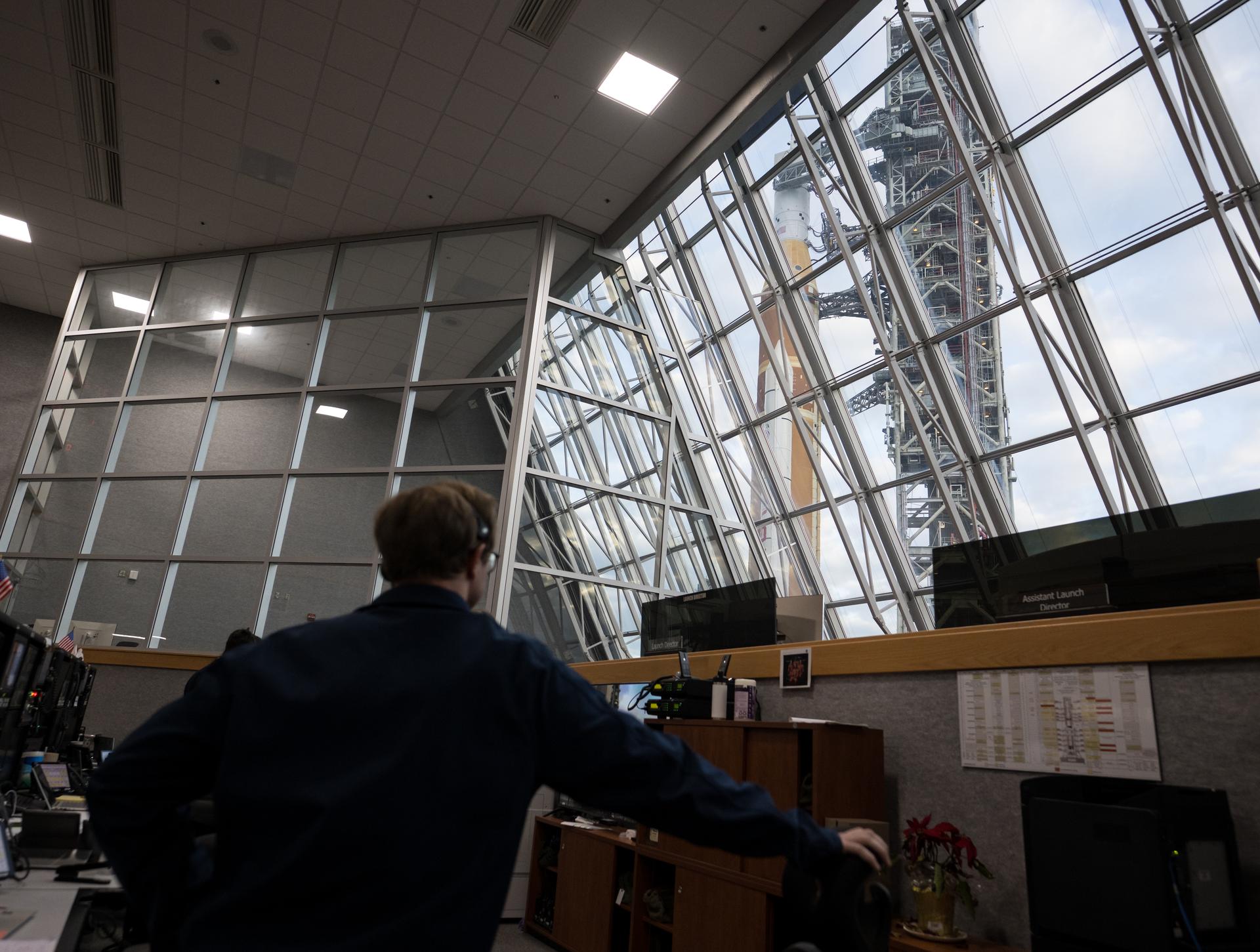 Members of the Artemis II launch team are seen on console in Firing Room One of the Rocco A. Petrone Launch Control Center as NASA’s Artemis II Space Launch System (SLS) rocket and Orion spacecraft, secured to the mobile launcher, roll out of High Bay 3 of the Vehicle Assembly Building to Launch Complex 39B, Saturday, Jan. 17, 2026, at NASA’s Kennedy Space Center in Florida. NASA’s Artemis II test flight will take Commander Reid Wiseman, Pilot Victor Glover, and Mission Specialist Christina Koch from NASA, and Mission Specialist Jeremy Hansen from the CSA (Canadian Space Agency), around the Moon and back to Earth no later than April 2026. Photo Credit: (NASA/Aubrey Gemignani)