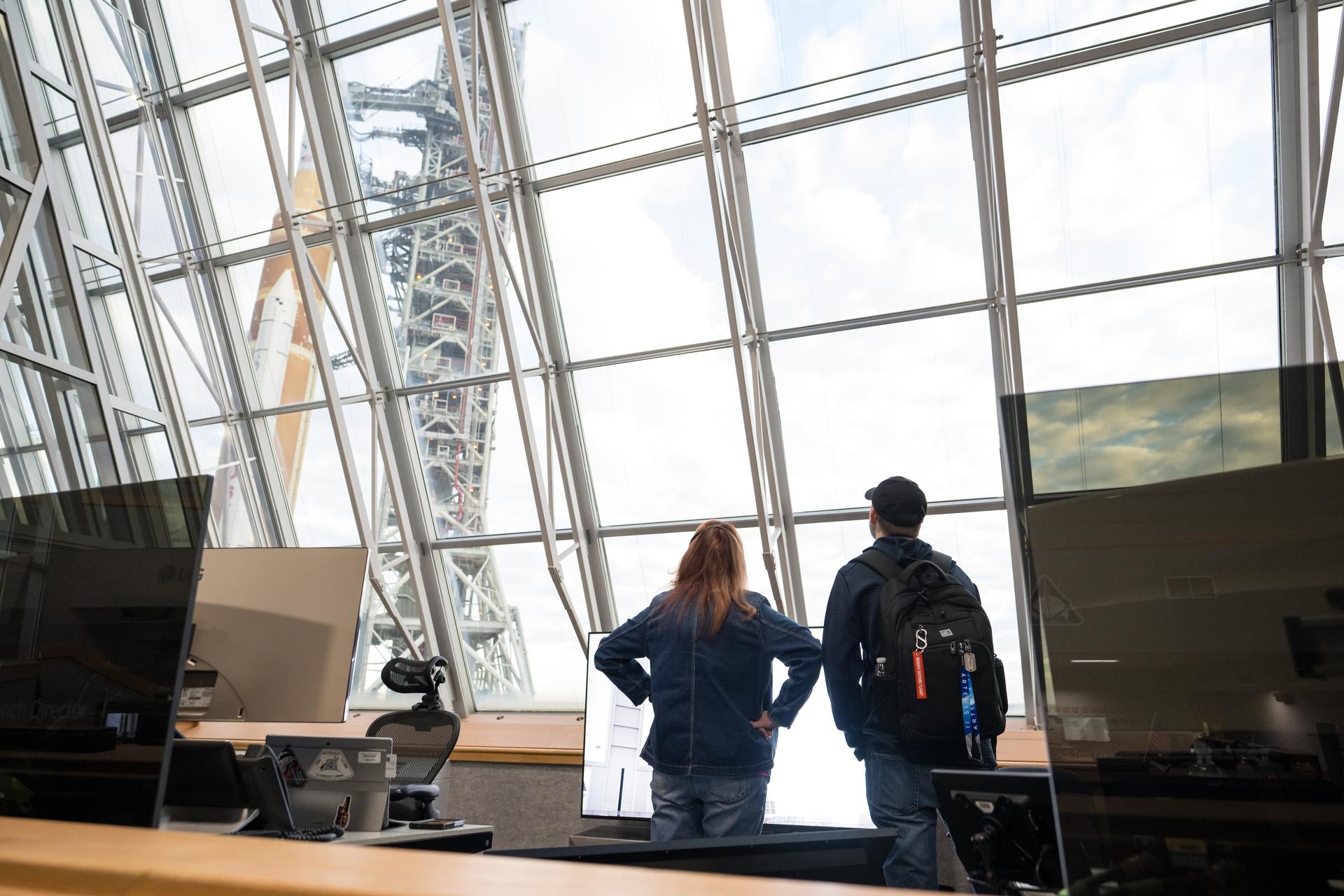 Charlie Blackwell-Thompson, Artemis II launch director at NASA's Kennedy Space Center, left, and Matt Czech, NASA’s Exploration Ground System’s Senior Vehicle Operations Manager are seen in Firing Room One of the Rocco A. Petrone Launch Control Center as NASA’s Artemis II Space Launch System (SLS) rocket and Orion spacecraft, secured to the mobile launcher, roll out of High Bay 3 of the Vehicle Assembly Building to Launch Complex 39B, Saturday, Jan. 17, 2026, at NASA’s Kennedy Space Center in Florida. NASA’s Artemis II test flight will take Commander Reid Wiseman, Pilot Victor Glover, and Mission Specialist Christina Koch from NASA, and Mission Specialist Jeremy Hansen from the CSA (Canadian Space Agency), around the Moon and back to Earth no later than April 2026. Photo Credit: (NASA/Aubrey Gemignani)