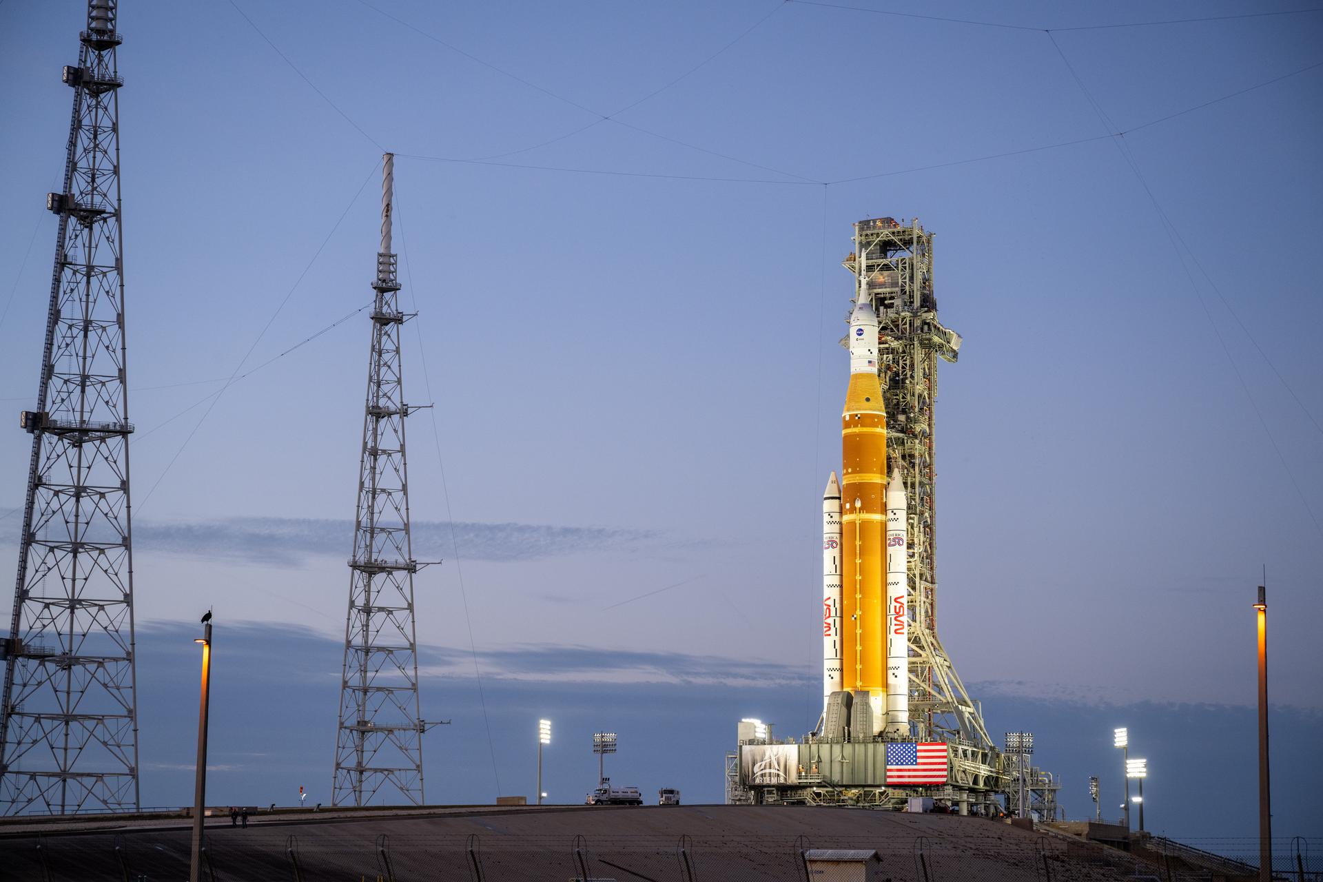 NASA’s Artemis II Space Launch System (SLS) rocket and Orion spacecraft are seen illuminated by lights at Launch Complex 39B, Saturday, Jan. 17, 2026, at NASA’s Kennedy Space Center in Florida. In the coming days, engineers will prepare for the wet dress rehearsal, a two-day test that simulates launch day. The Artemis II test flight will take Commander Reid Wiseman, Pilot Victor Glover, and Mission Specialist Christina Koch from NASA, and Mission Specialist Jeremy Hansen from the CSA (Canadian Space Agency), around the Moon and back to Earth no later than April 2026. Photo Credit: (NASA/Keegan Barber)