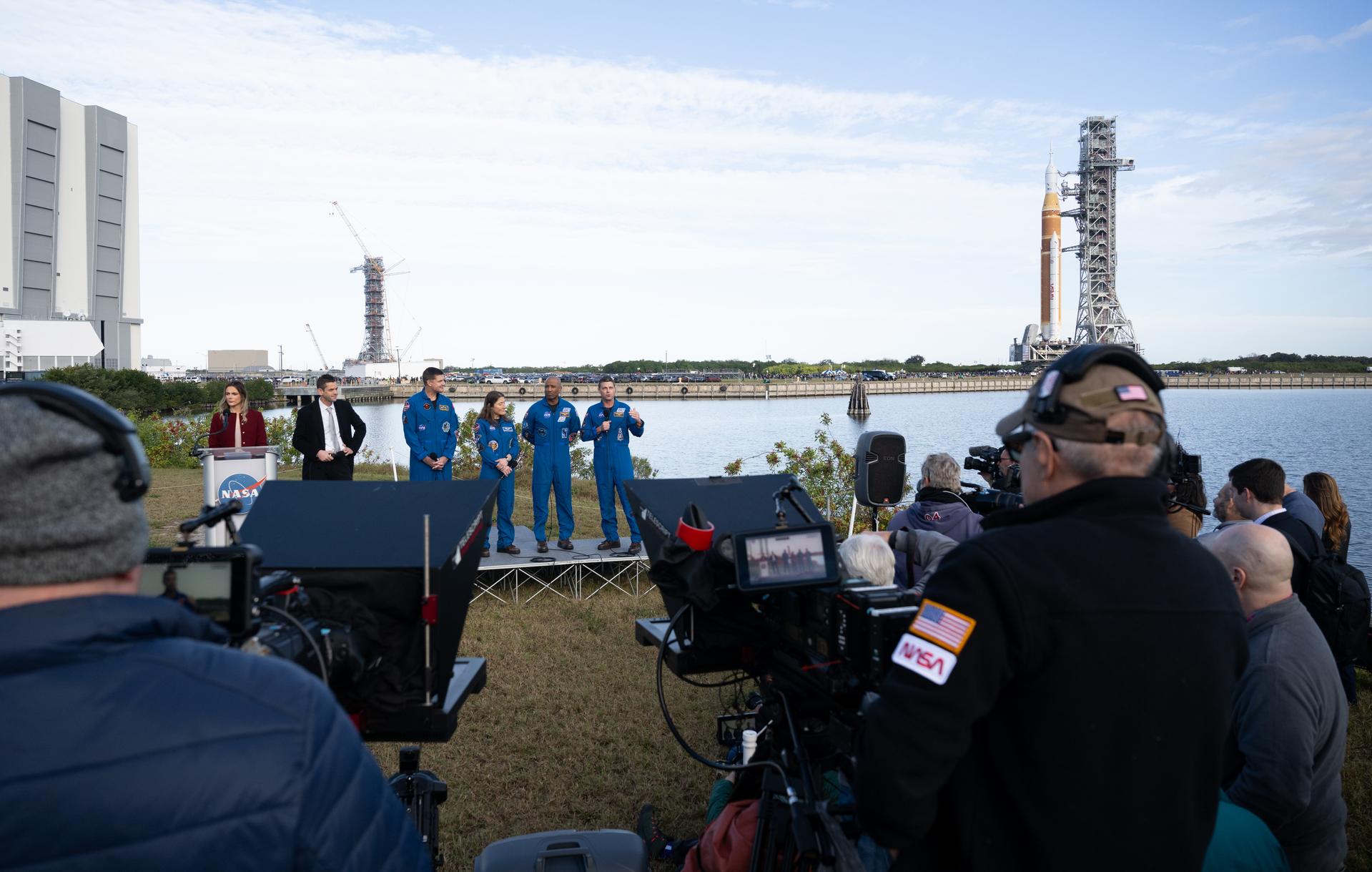 NASA astronaut Reid Wiseman, Artemis II commander, right, speaks to members of the media alongside NASA press secretary Bethany Stevens, left, NASA Administrator Jared Isaacman, CSA (Canadian Space Agency) astronaut Jeremy Hansen, Artemis II mission specialist, NASA astronaut Christina Koch, Artemis II mission specialist, and NASA astronaut Victor Glover, Artemis II pilot, during NASA’s Artemis II SLS (Space Launch System) rocket and Orion spacecraft rollout to Launch Complex 39B at NASA’s Kennedy Space Center in Florida on Saturday, Jan. 17, 2026. In the coming weeks, engineers will prepare for the wet dress rehearsal, a two-day test that simulates launch day. The Artemis II test flight will take Commander Reid Wiseman, Pilot Victor Glover, and Mission Specialist Christina Koch from NASA, and Mission Specialist Jeremy Hansen from the CSA (Canadian Space Agency), around the Moon and back to Earth no later than April 2026. Photo Credit: (NASA/Joel Kowsky)