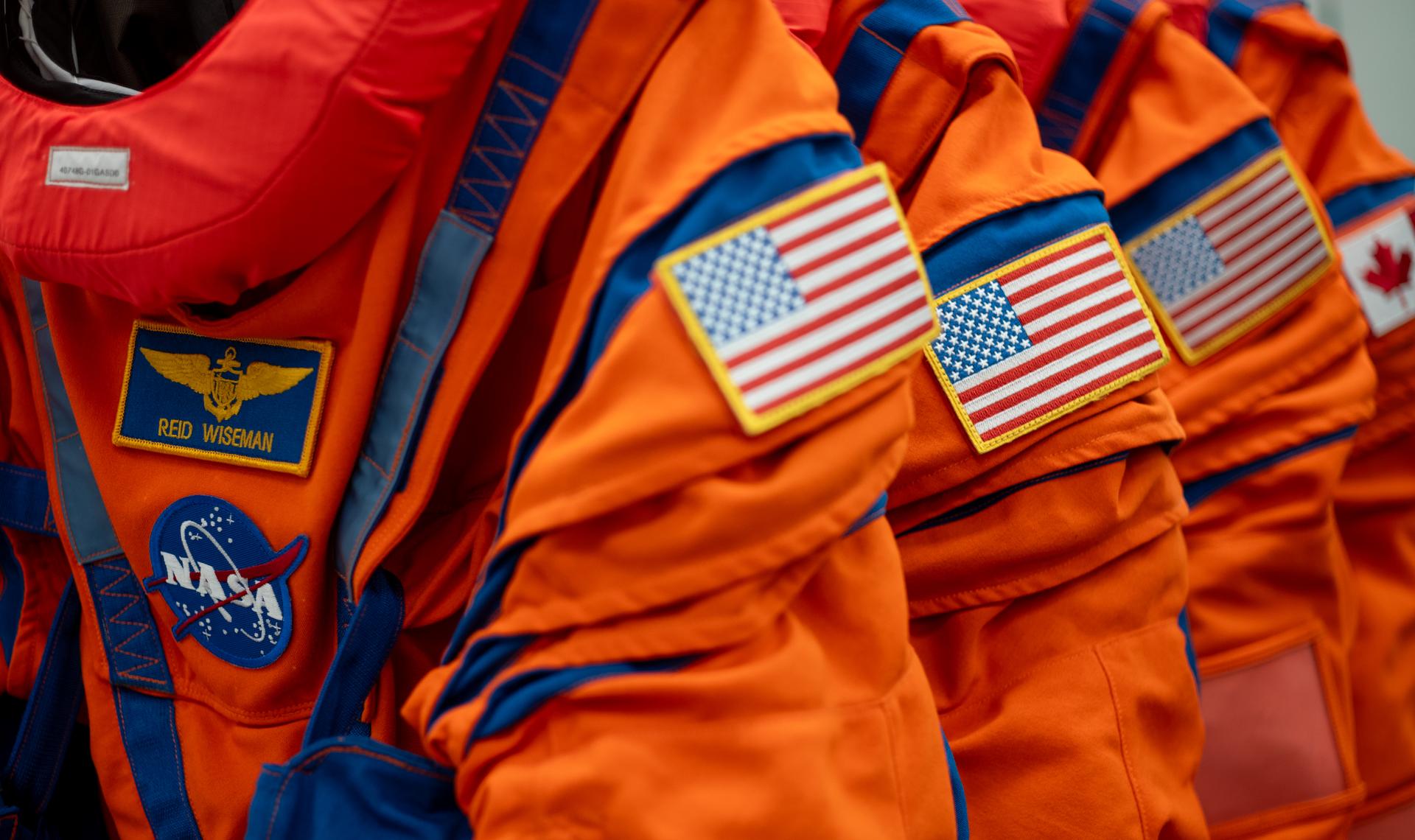 The Orion Crew Survival System suit that will be worn by Artemis II Commander Reid Wiseman of NASA and those  that will be worn by Pilot Victor Glover, and Mission Specialist Christina Koch of NASA, and Mission Specialist Jeremy Hansen of the CSA (Canadian Space Agency) are seen in the suit-up room of the Neil A. Armstrong Operations and Checkout Building, Saturday, Jan. 17, 2026, at NASA’s Kennedy Space Center in Florida. NASA’s Artemis II test flight will take Wiseman, Glover, Koch, and Hansen around the Moon and back to Earth no later than April 2026. Photo Credit: (NASA/Joel Kowsky)