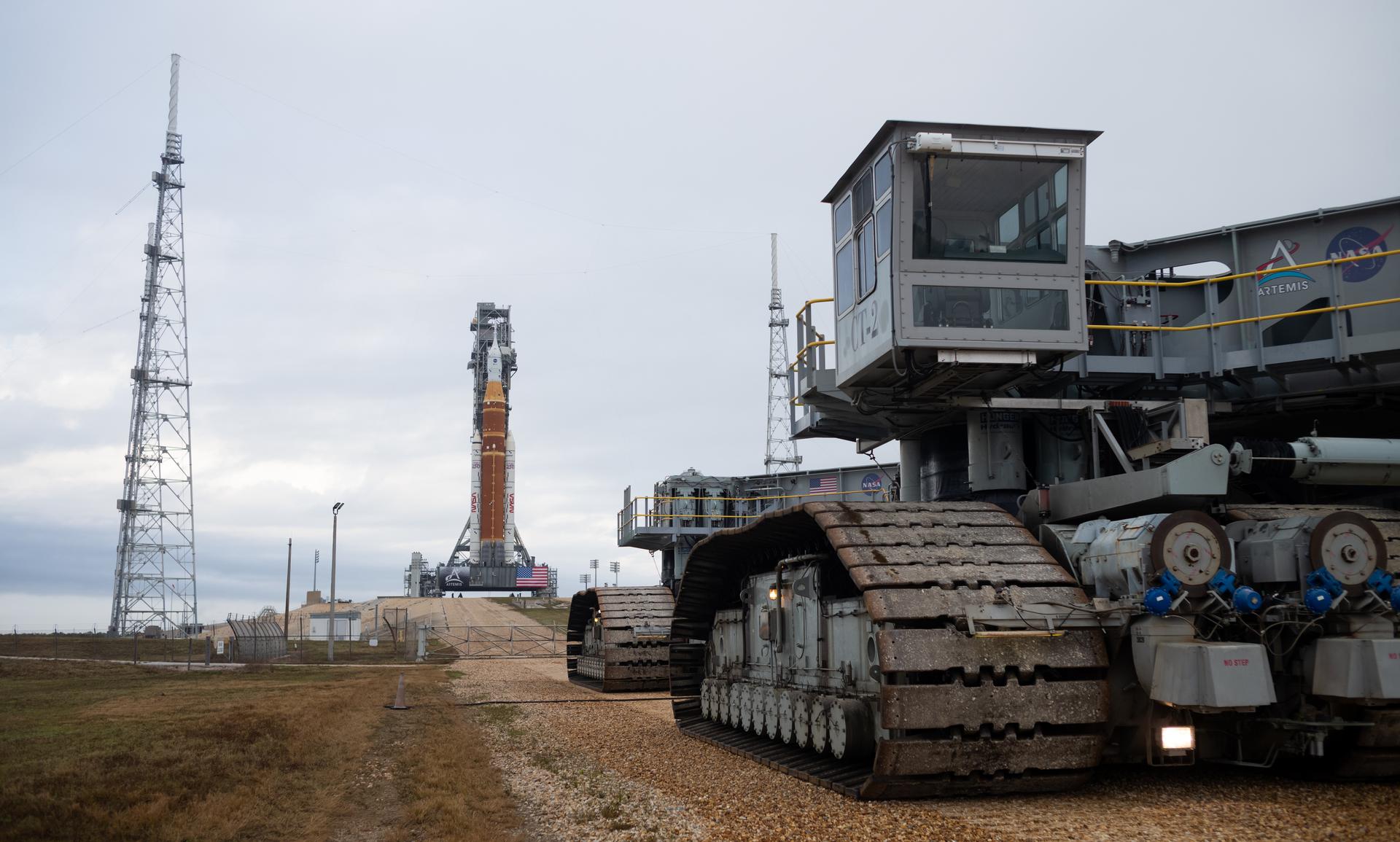 NASA’s Artemis II Space Launch System (SLS) rocket and Orion spacecraft are seen atop a mobile launcher at Launch Complex 39B, Sunday, Jan. 18, 2026, after being rolled out to the launch pad at NASA’s Kennedy Space Center in Florida. NASA’s Artemis II test flight will take Commander Reid Wiseman, Pilot Victor Glover, and Mission Specialist Christina Koch from NASA, and Mission Specialist Jeremy Hansen from the CSA (Canadian Space Agency), around the Moon and back to Earth no later than April 2026. Photo Credit: (NASA/Joel Kowsky)