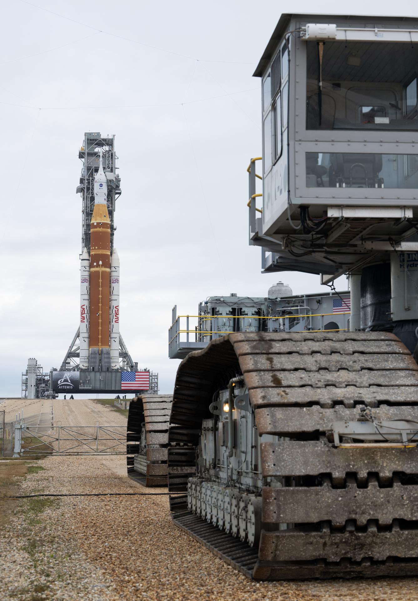 NASA’s Artemis II Space Launch System (SLS) rocket and Orion spacecraft are seen atop a mobile launcher at Launch Complex 39B, Sunday, Jan. 18, 2026, after being rolled out to the launch pad at NASA’s Kennedy Space Center in Florida. NASA’s Artemis II test flight will take Commander Reid Wiseman, Pilot Victor Glover, and Mission Specialist Christina Koch from NASA, and Mission Specialist Jeremy Hansen from the CSA (Canadian Space Agency), around the Moon and back to Earth no later than April 2026. Photo Credit: (NASA/Joel Kowsky)