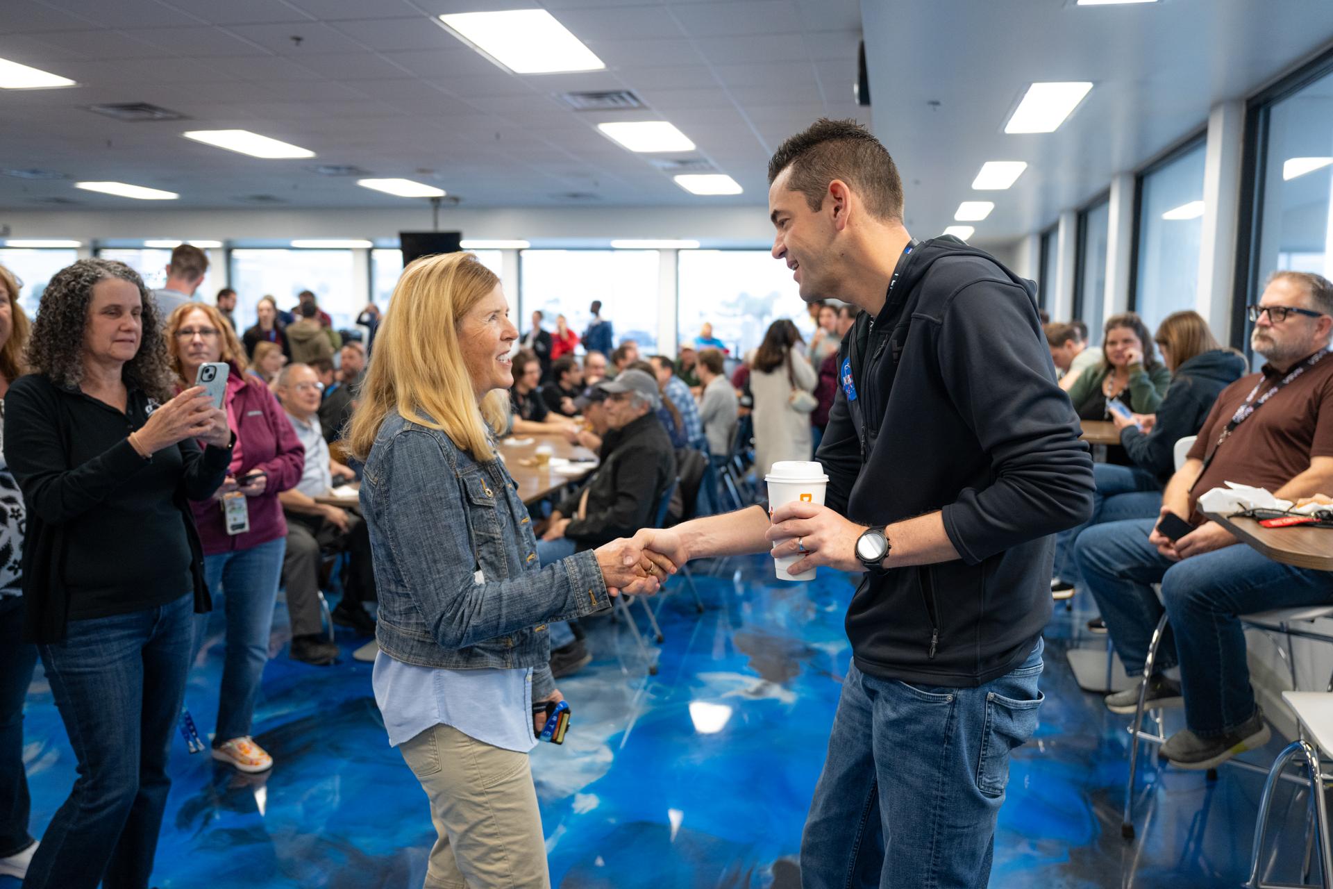 NASA Administrator Jared Isaacman, right, greets a member of the workforce, Thursday, Jan. 22, 2026, at NASA’s Kennedy Space Center in Florida. Photo Credit: (NASA/John Kraus)