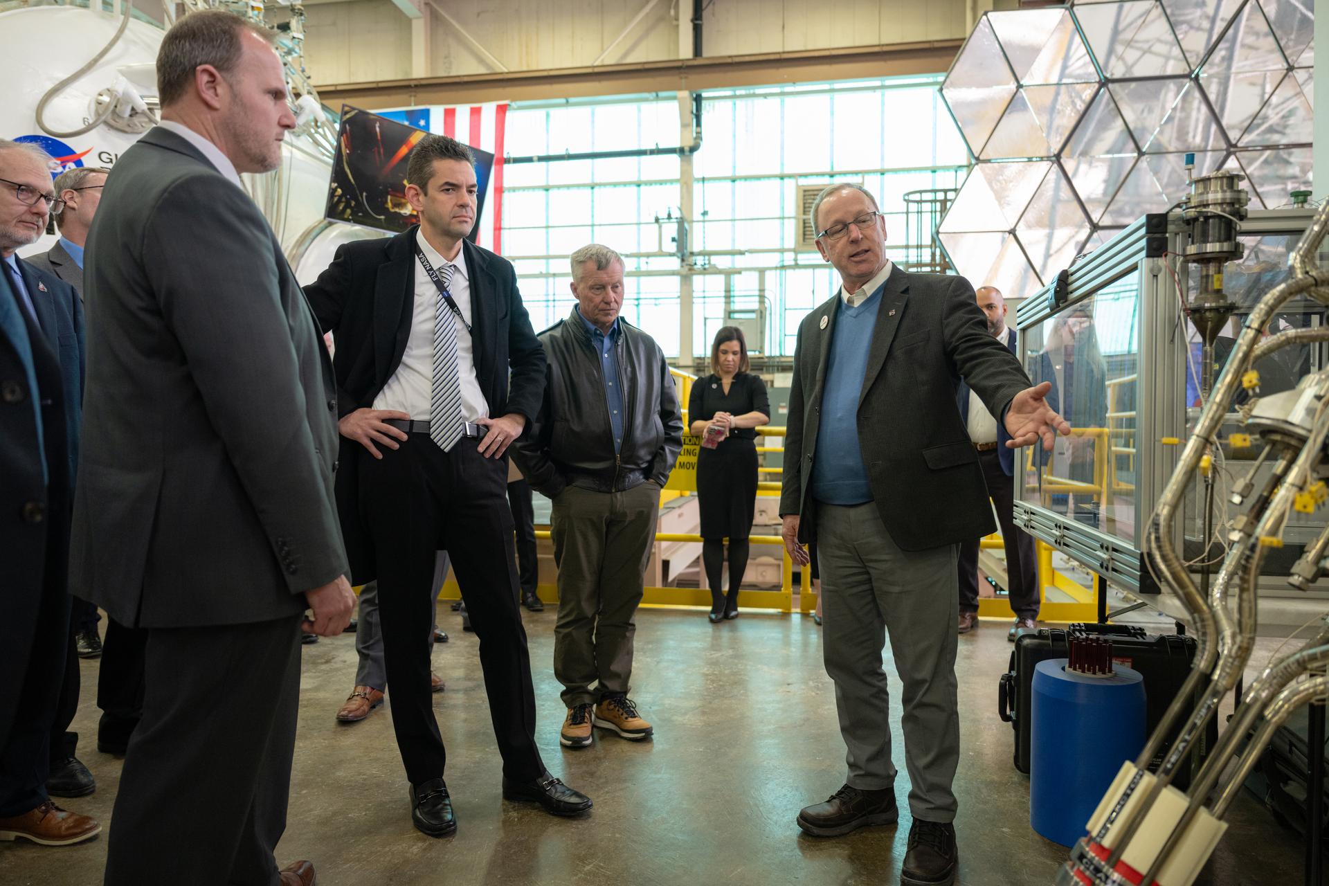 NASA Administrator Jared Isaacman, center left, is shown the Kilowatt Reactor Using Stirling TechnologY (KRUSTY) by Lee Mason, fission surface power chief technologist, right, as he tours the Electric Propulsion and Power Laboratory, Tuesday, Jan. 27, 2026, at NASA’s Glenn Research Center in Cleveland, Ohio. Glenn marks the eleventh stop in Isaacman’s roadshow to visit NASA facilities and engage directly with the agency’s workforce. Photo Credit: (NASA/John Kraus)