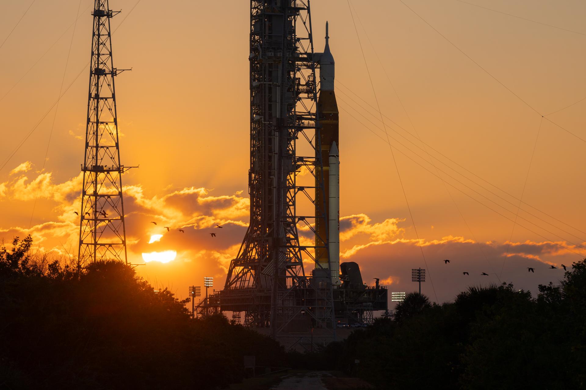 NASA’s Artemis II Space Launch System (SLS) rocket and Orion spacecraft are seen standing atop a mobile launcher at Launch Complex 39B at sunrise, Sunday, Feb. 1, 2026, at NASA’s Kennedy Space Center in Florida. NASA’s Artemis II test flight will take Commander Reid Wiseman, Pilot Victor Glover, and Mission Specialist Christina Koch from NASA, and Mission Specialist Jeremy Hansen from the CSA (Canadian Space Agency), around the Moon and back to Earth no later than April 2026. Photo Credit: (NASA/John Kraus)