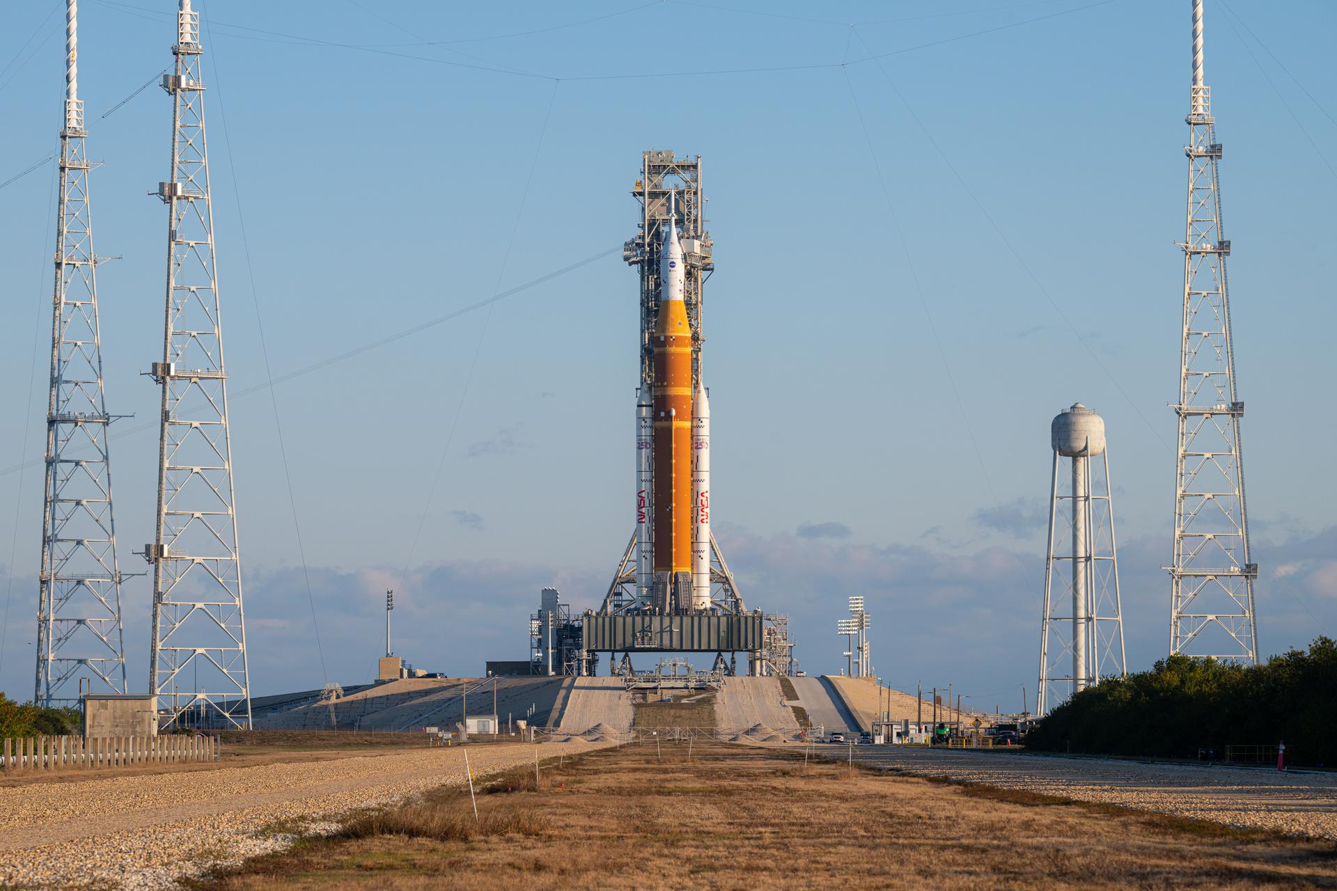 NASA’s Artemis II Space Launch System (SLS) rocket and Orion spacecraft are seen standing atop a mobile launcher at Launch Complex 39B, Sunday, Feb. 1, 2026, at NASA’s Kennedy Space Center in Florida. NASA’s Artemis II test flight will take Commander Reid Wiseman, Pilot Victor Glover, and Mission Specialist Christina Koch from NASA, and Mission Specialist Jeremy Hansen from the CSA (Canadian Space Agency), around the Moon and back to Earth no later than April 2026. Photo Credit: (NASA/John Kraus)
