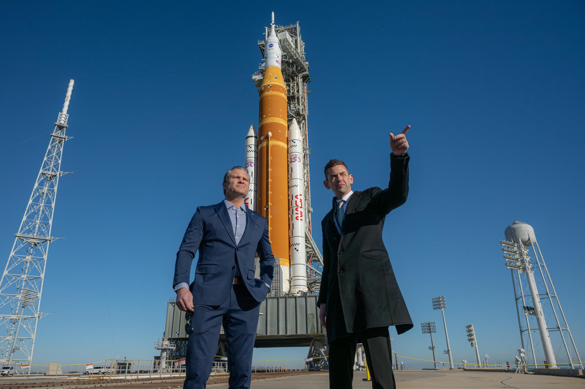 NASA Administrator Jared Isaacman, right, and Secretary of War Pete Hegseth, left, visit NASA’s Artemis II SLS (Space Launch System) rocket and Orion spacecraft at Launch Complex 39B, Monday, Feb. 2, 2026, at NASA’s Kennedy Space Center in Florida. Photo Credit: (NASA/John Kraus)