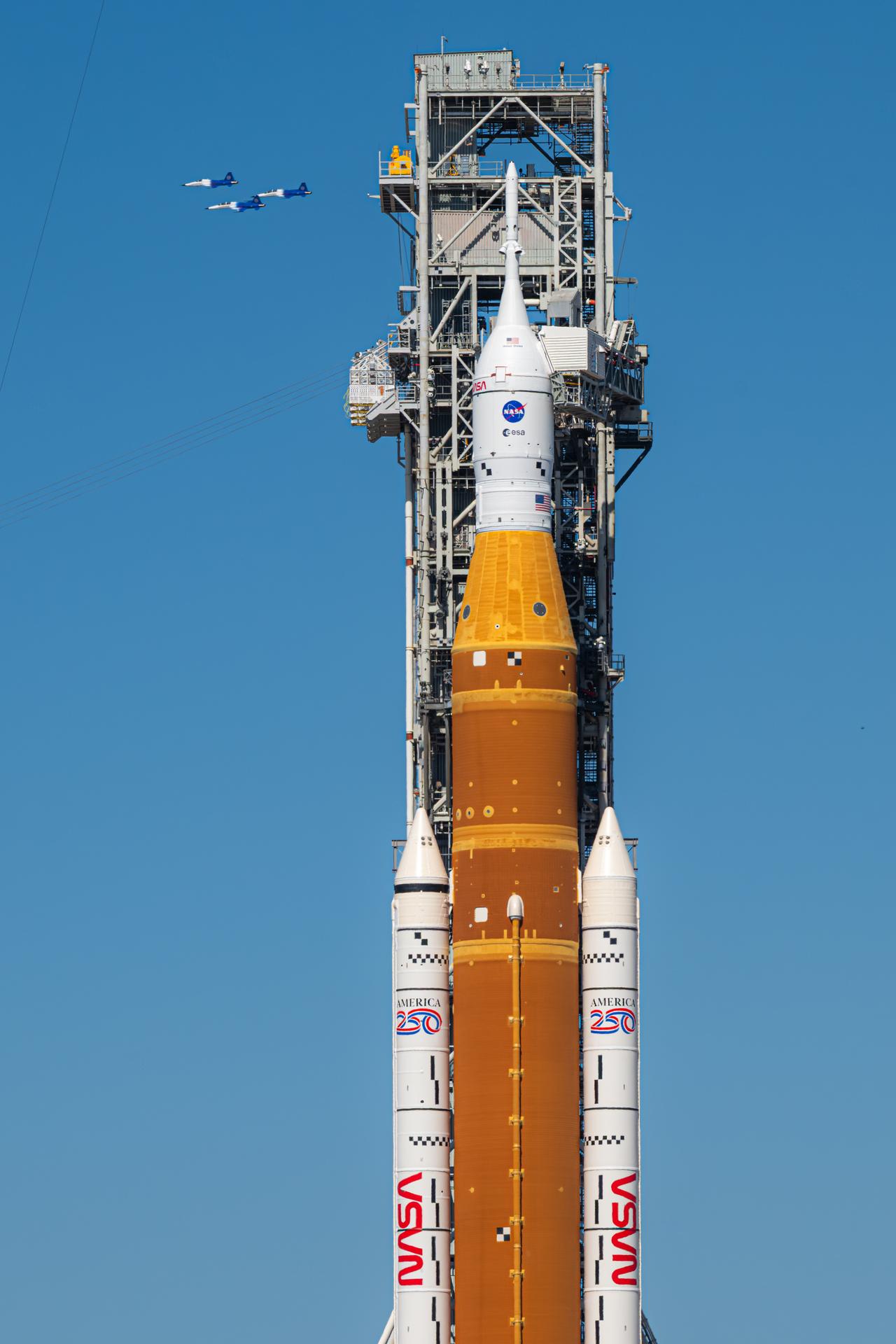 NASA Administrator Jared Isaacman conducts a formation flight with three of his personal F-5 aircraft, Sunday, Feb. 8, 2026, at NASA’s Kennedy Space Center in Florida. The formation flew near the Artemis II SLS (Space Launch System) rocket and Orion spacecraft at Launch Complex 39B and the surrounding area at Kennedy. Photo Credit: (NASA/John Kraus)