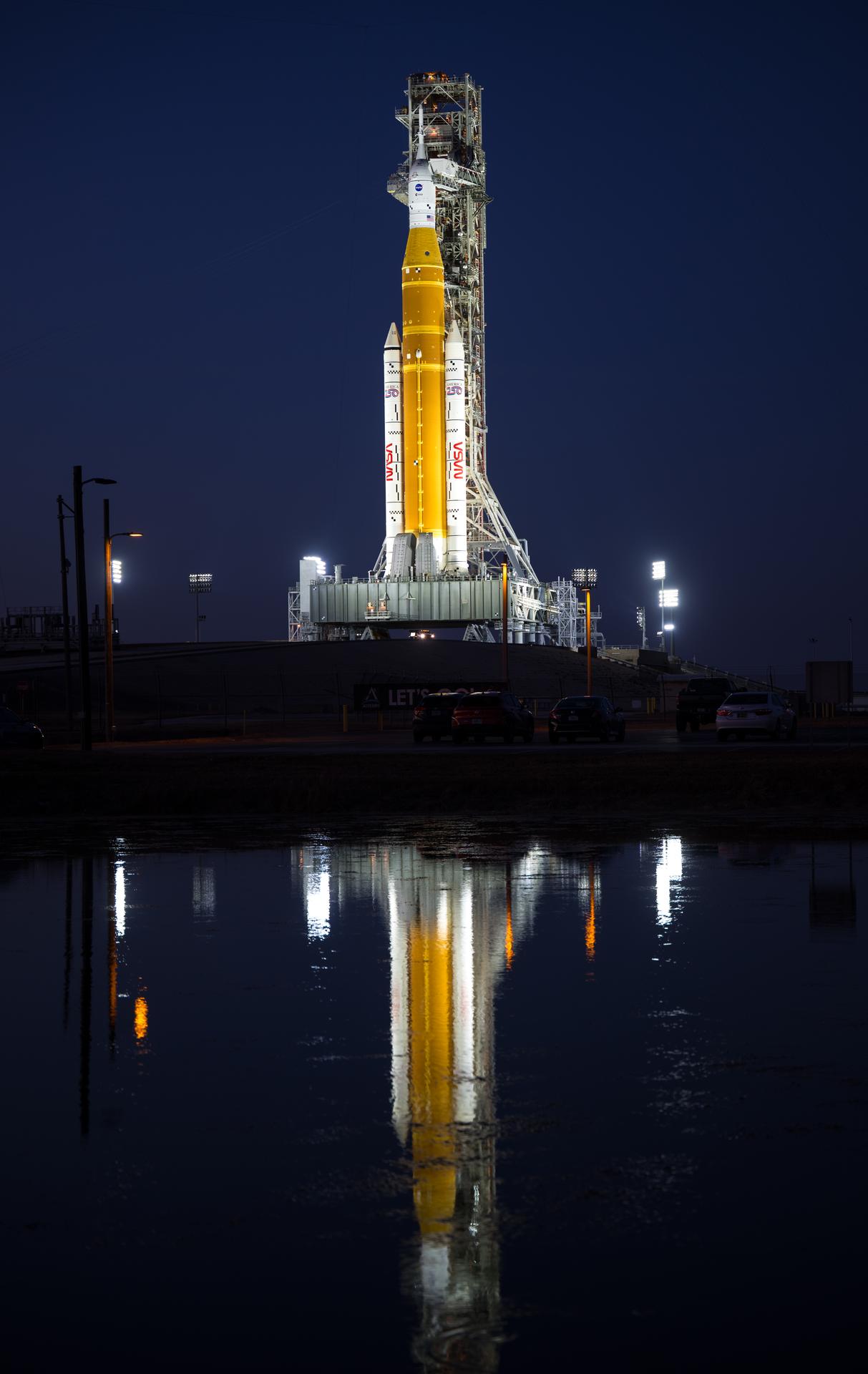 NASA’s Artemis II Space Launch System (SLS) rocket and Orion spacecraft are seen illuminated by lights at Launch Complex 39B, Tuesday, Feb. 10, 2026, at NASA’s Kennedy Space Center in Florida. In the coming days, engineers will prepare for the second wet dress rehearsal, a two-day test that simulates launch day. The Artemis II test flight will take Commander Reid Wiseman, Pilot Victor Glover, and Mission Specialist Christina Koch from NASA, and Mission Specialist Jeremy Hansen from the CSA (Canadian Space Agency), around the Moon and back to Earth no later than April 2026. Photo Credit: (NASA/Aubrey Gemignani)