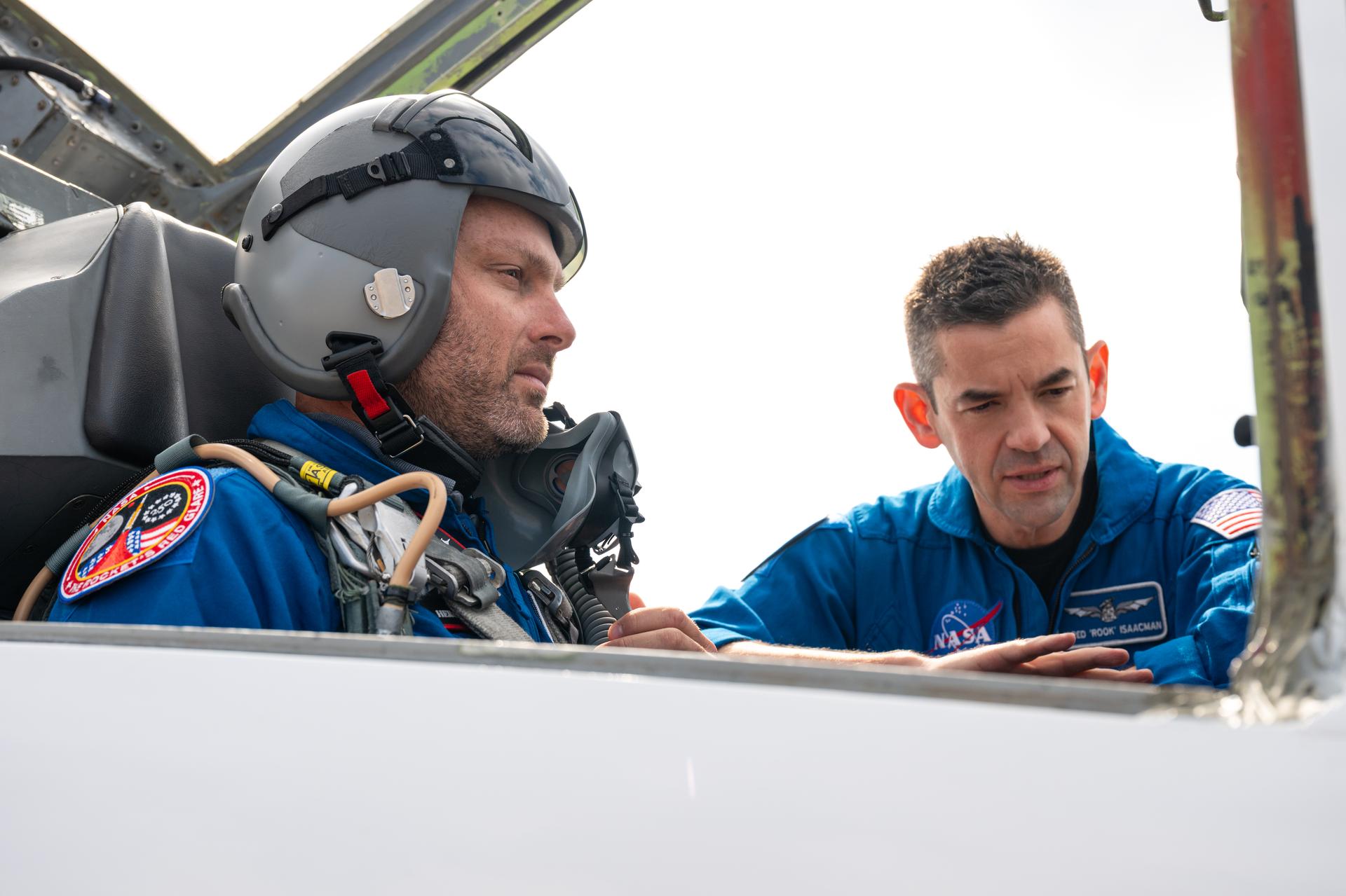 NASA employee Jonathan Baker, chief of the spaceport development division at NASA’s Kennedy Space Center, left, is seen before an employee incentive flying event with NASA Administrator Jared Isaacman, right, and his personal F-5 aircraft, Thursday, Feb. 12, 2026, at NASA’s Kennedy Space Center in Florida. Photo Credit: (NASA/John Kraus)