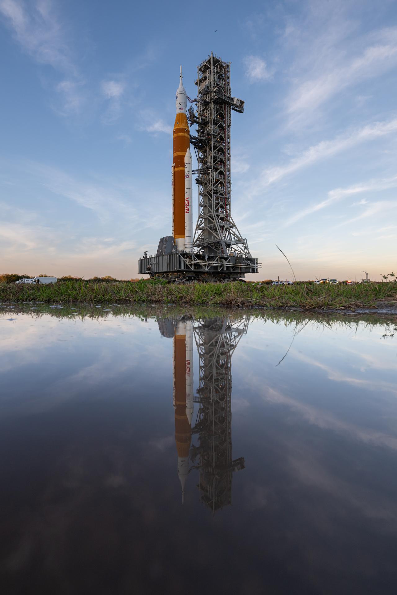 NASA’s Artemis II SLS (Space Launch System) rocket and Orion spacecraft roll back to the Vehicle Assembly Building, Wednesday, Feb. 25, 2026, at NASA’s Kennedy Space Center in Florida. Teams will troubleshoot a helium flow issue experienced on the rocket’s interim cryogenic propulsion stage before rolling the rocket and spacecraft back to Launch Complex 39B for the Artemis II mission around the Moon. Photo Credit: (NASA/John Kraus)