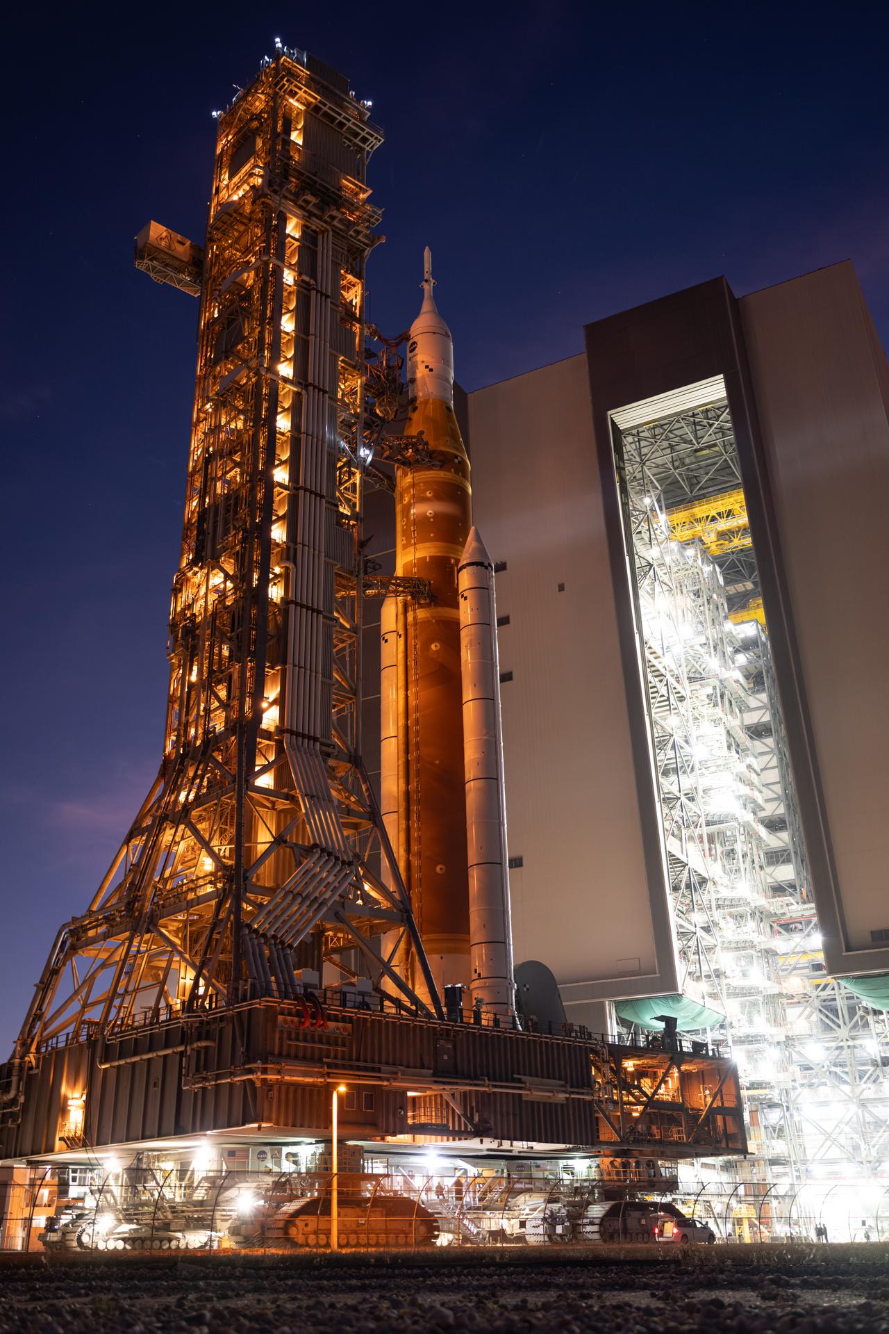 NASA’s Artemis II SLS (Space Launch System) rocket and Orion spacecraft roll back to the Vehicle Assembly Building, Wednesday, Feb. 25, 2026, at NASA’s Kennedy Space Center in Florida. Teams will troubleshoot a helium flow issue experienced on the rocket’s interim cryogenic propulsion stage before rolling the rocket and spacecraft back to Launch Complex 39B for the Artemis II mission around the Moon. Photo Credit: (NASA/John Kraus)