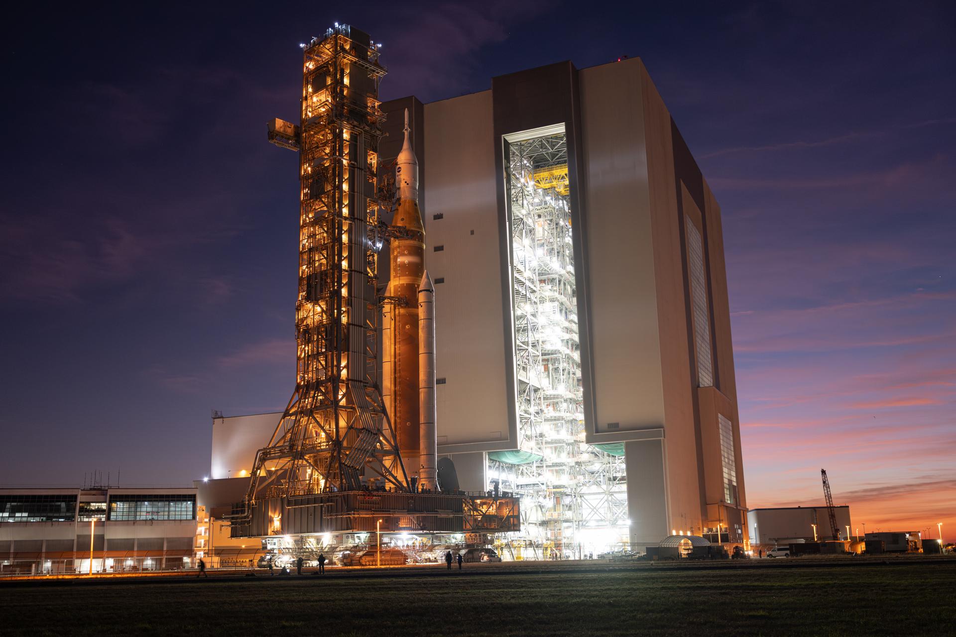 NASA’s Artemis II SLS (Space Launch System) rocket and Orion spacecraft roll back to the Vehicle Assembly Building, Wednesday, Feb. 25, 2026, at NASA’s Kennedy Space Center in Florida. Teams will troubleshoot a helium flow issue experienced on the rocket’s interim cryogenic propulsion stage before rolling the rocket and spacecraft back to Launch Complex 39B for the Artemis II mission around the Moon. Photo Credit: (NASA/John Kraus)