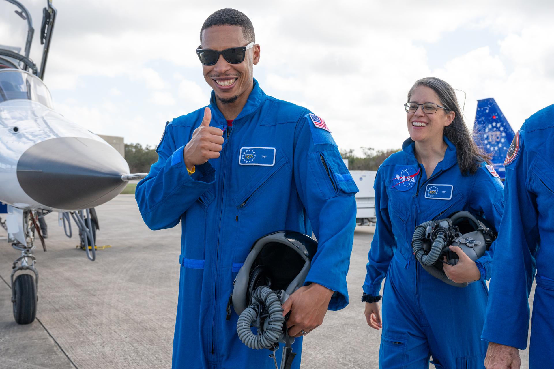 Matthew Mickens, project scientist, space crop production at NASA’s Kennedy Space Center, left, and Clara Wright, chief of the laboratories, development, and testing division within the engineering directorate at NASA’s Kennedy Space Center, right, are seen following an employee incentive flying event using NASA Administrator Jared Isaacman's personal F-5 aircraft, Friday, March 6, 2026, at NASA’s Kennedy Space Center in Florida. Photo Credit: (NASA/John Kraus)