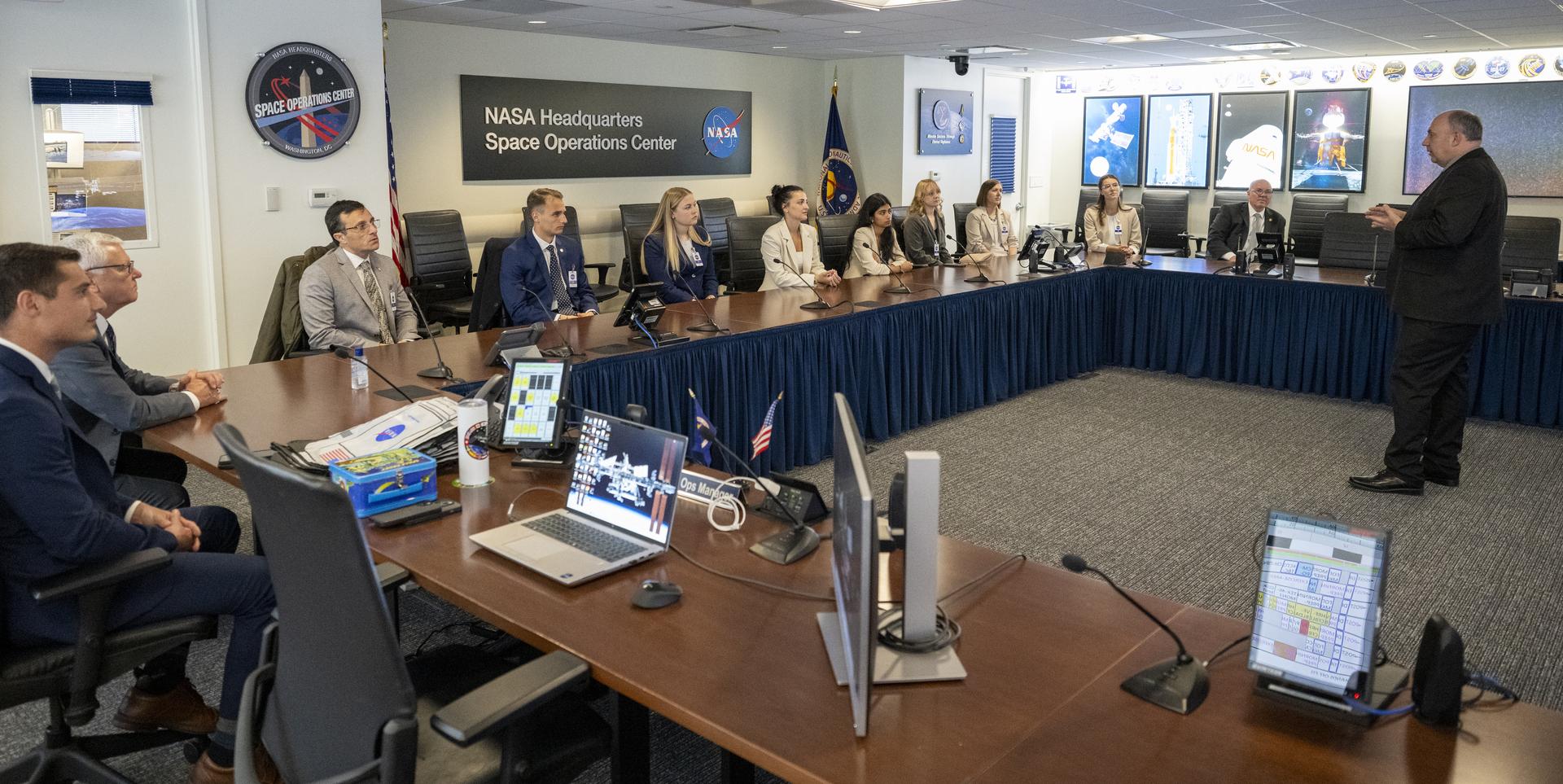 NASA Headquarters Space Operations Center (SOC) Manager Kevin Metrocavage, right, speaks with Embry‑Riddle Aeronautical University students and staff about the International Space Station in the SOC, Thursday, March 19, 2026, at the Mary W. Jackson NASA Headquarters building in Washington. The group is visiting NASA Headquarters after six Embry‑Riddle Aeronautical University students were named to the Aviation Week Network 20 Twenties Class of 2026, which recognizes outstanding aerospace-focused university students. Photo Credit: (NASA/Keegan Barber)