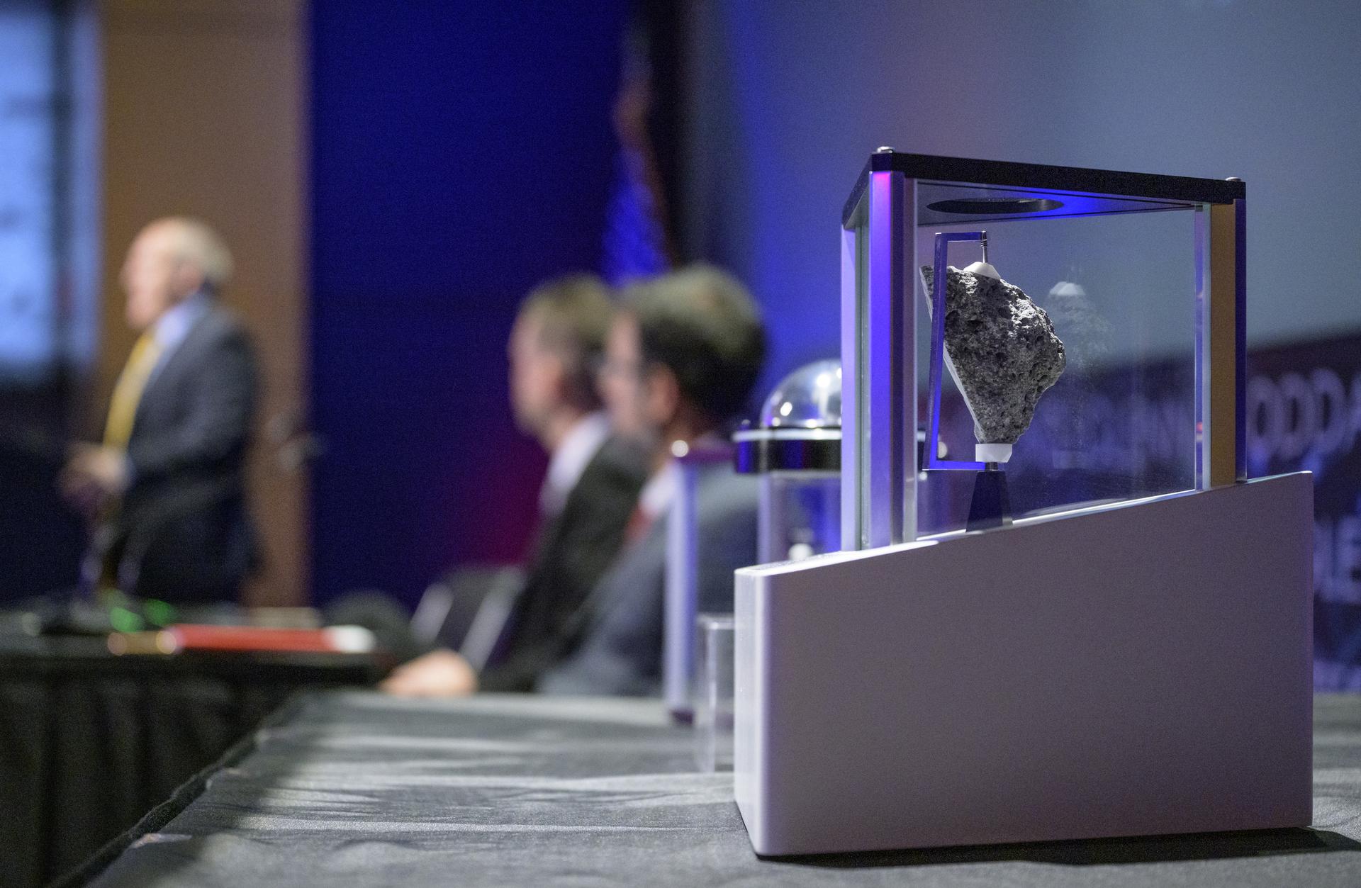 Moon rocks are seen as NASA Moon Base Program Executive Carlos Garcia-Galan speaks during an event where NASA is outlining how the agency is executing President Donald J. Trump’s National Space Policy and accelerating preparations for America’s return to the surface of the Moon by 2028, Tuesday, March 24, 2026, at the Mary W. Jackson NASA Headquarters building in Washington. During the event NASA leadership provided updates on mission priorities, including sending the first astronauts to the lunar surface in more than 50 years, establishing the initial elements of a permanent lunar base, getting America underway in space on nuclear propulsion, and other objectives. Photo Credit: (NASA/Bill Ingalls)