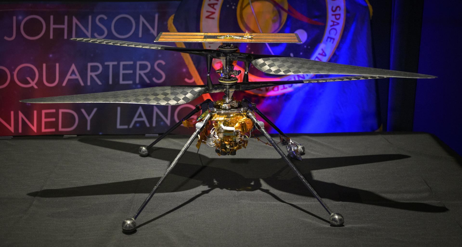 Ingenuity Mars Helicopter, Engineering Design Model 1, is seen on display during an event where NASA is outlining how the agency is executing President Donald J. Trump’s National Space Policy and accelerating preparations for America’s return to the surface of the Moon by 2028, Tuesday, March 24, 2026, at the Mary W. Jackson NASA Headquarters building in Washington. During the event NASA leadership provided updates on mission priorities, including sending the first astronauts to the lunar surface in more than 50 years, establishing the initial elements of a permanent lunar base, getting America underway in space on nuclear propulsion, and other objectives. Photo Credit: (NASA/Bill Ingalls)