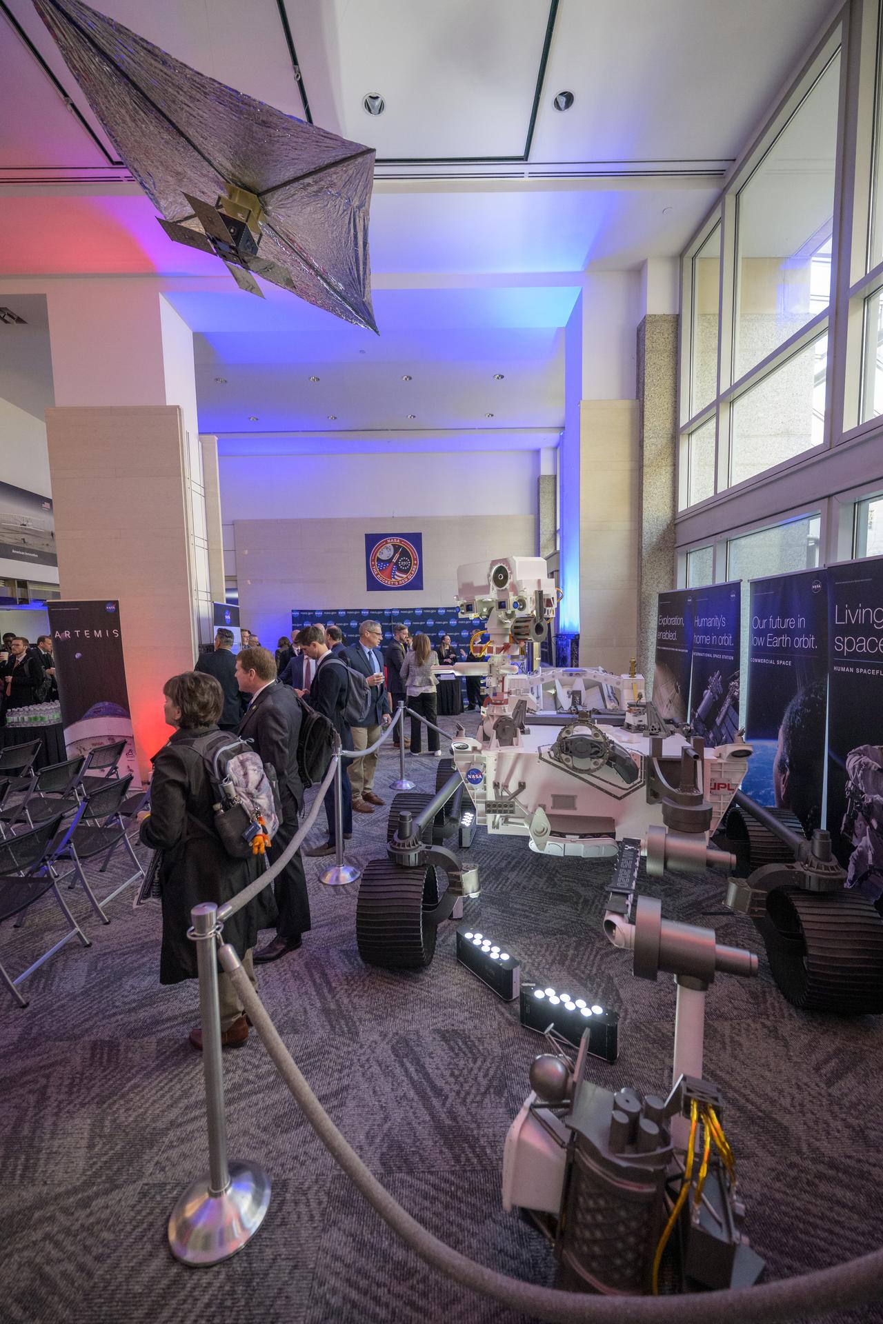 NASA Headquarters lobby is seen with models of the Mars 2020 Perseverance Rover, and Advanced Composite Solar Sail System (ACS3) on display ahead of an event where NASA outlined how the agency is executing President Donald J. Trump’s National Space Policy and accelerating preparations for America’s return to the surface of the Moon by 2028, Tuesday, March 24, 2026, at the Mary W. Jackson NASA Headquarters building in Washington. During the event NASA leadership provided updates on mission priorities, including sending the first astronauts to the lunar surface in more than 50 years, establishing the initial elements of a permanent lunar base, getting America underway in space on nuclear propulsion, and other objectives. Photo Credit: (NASA/Bill Ingalls)