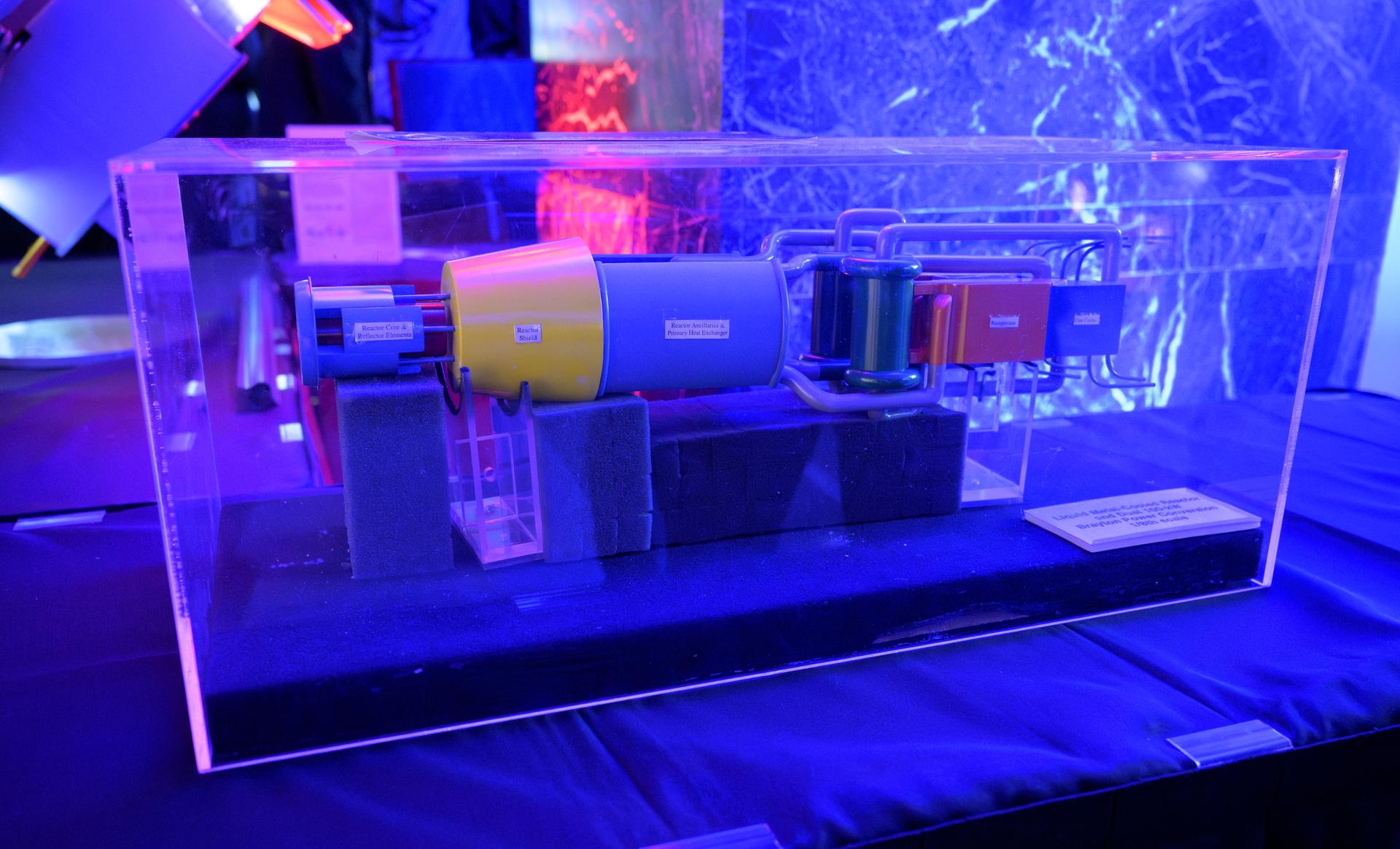 A model of a liquid metal-cooled reactor, dual 100-kw Brayton Power Conversion is seen on display during an event where NASA is outlining how the agency is executing President Donald J. Trump’s National Space Policy and accelerating preparations for America’s return to the surface of the Moon by 2028, Tuesday, March 24, 2026, at the Mary W. Jackson NASA Headquarters building in Washington. During the event NASA leadership provided updates on mission priorities, including sending the first astronauts to the lunar surface in more than 50 years, establishing the initial elements of a permanent lunar base, getting America underway in space on nuclear propulsion, and other objectives. Photo Credit: (NASA/Bill Ingalls)