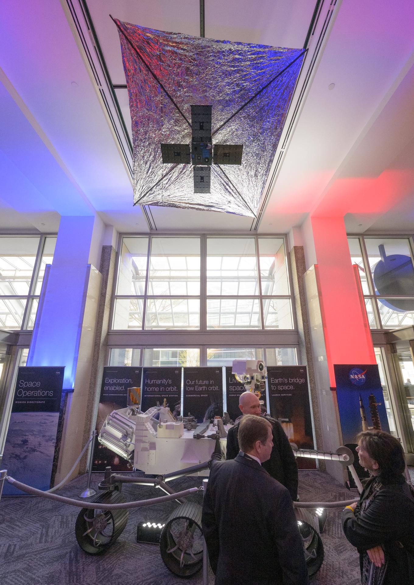 NASA Headquarters lobby is seen with models of the Mars 2020 Perseverance Rover, and Advanced Composite Solar Sail System (ACS3) on display ahead of an event where NASA outlined how the agency is executing President Donald J. Trump’s National Space Policy and accelerating preparations for America’s return to the surface of the Moon by 2028, Tuesday, March 24, 2026, at the Mary W. Jackson NASA Headquarters building in Washington. During the event NASA leadership provided updates on mission priorities, including sending the first astronauts to the lunar surface in more than 50 years, establishing the initial elements of a permanent lunar base, getting America underway in space on nuclear propulsion, and other objectives. Photo Credit: (NASA/Bill Ingalls)