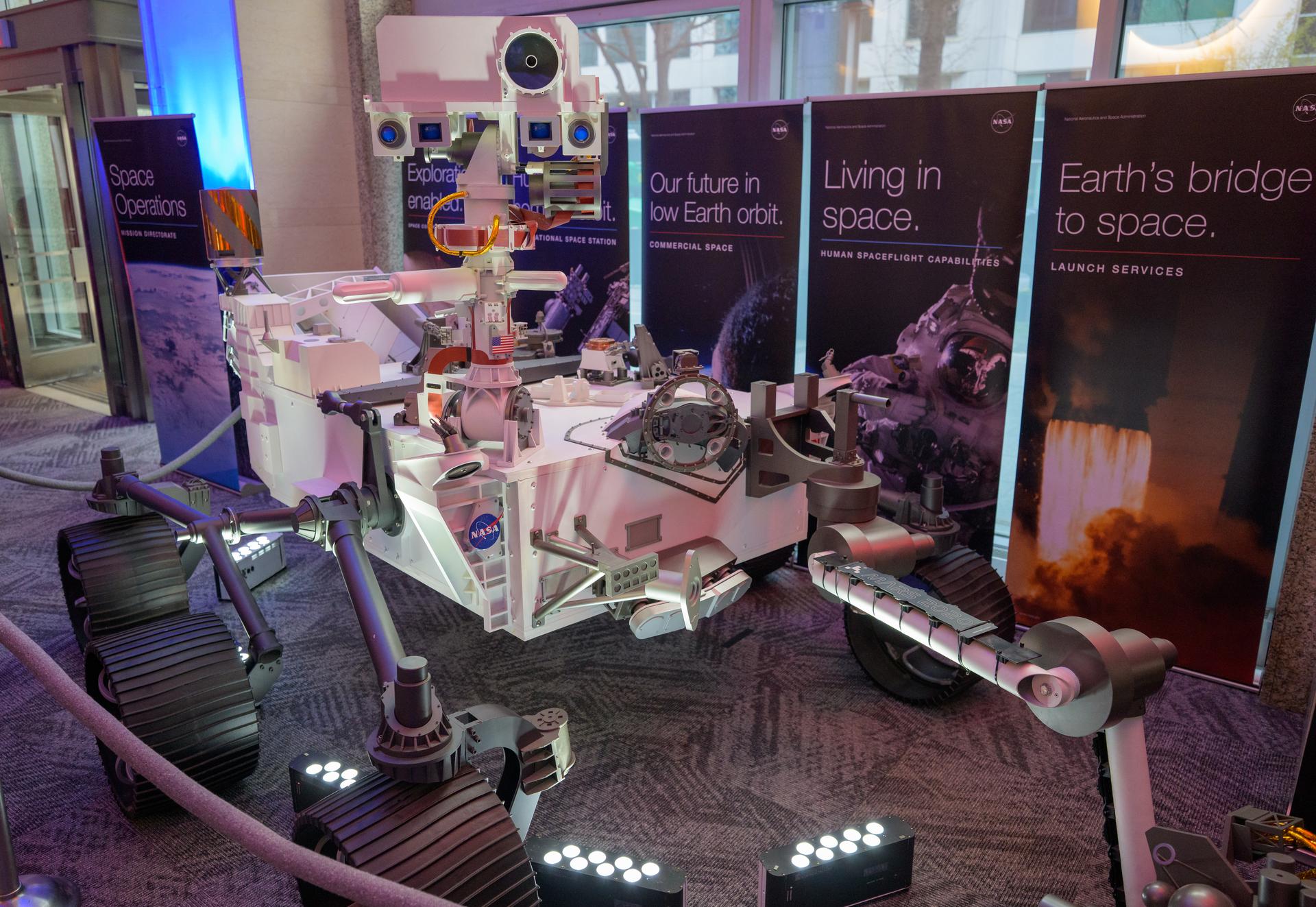 A model of the Mars 2020 Perseverance Rover is seen in the NASA Headquarters lobby during a 2-day event where NASA outlined how the agency is executing President Donald J. Trump’s National Space Policy and accelerating preparations for America’s return to the surface of the Moon by 2028, Wednesday, March 25, 2026, at the Mary W. Jackson NASA Headquarters building in Washington. During the event NASA leadership provided updates on mission priorities, including sending the first astronauts to the lunar surface in more than 50 years, establishing the initial elements of a permanent lunar base, getting America underway in space on nuclear propulsion, and other objectives. Photo Credit: (NASA/Bill Ingalls)