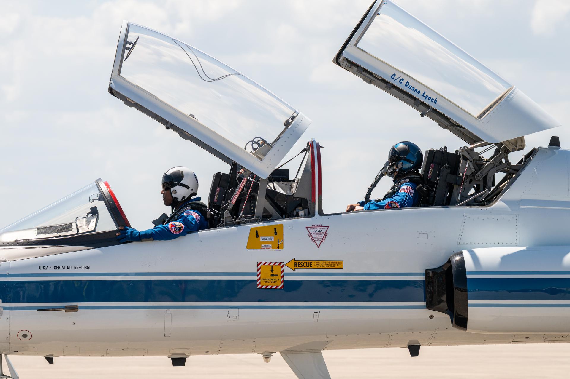 NASA astronauts Victor Glover, Artemis II pilot, and Christina Koch, Artemis II mission specialist, are seen in a T-38 aircraft, Friday, March 27, 2026, after arriving at the Launch and Landing Facility at NASA’s Kennedy Space Center in Florida. The Artemis II mission will launch the crew on a 10-day journey around the Moon and back no earlier than April 1. Photo Credit: (NASA/John Kraus)