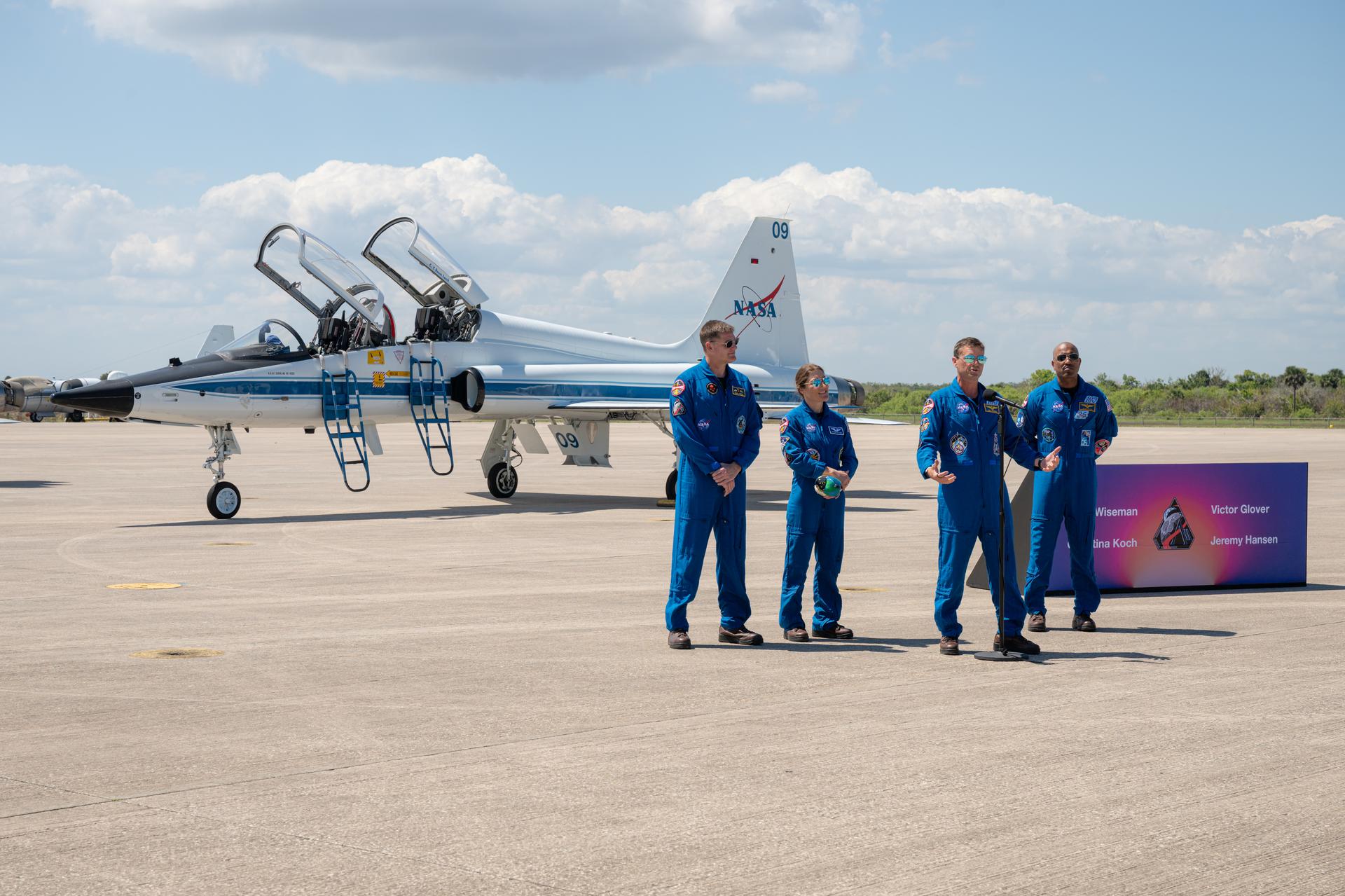 The Artemis II crew of CSA (Canadian Space Agency) astronaut Jeremy Hansen, Artemis II mission specialist; NASA astronaut Christina Koch, Artemis II mission specialist; NASA astronaut Reid Wiseman, Artemis II commander; and NASA astronaut Victor Glover, Artemis II pilot, participate in a press conference, Friday, March 27, 2026, after arriving at the Launch and Landing Facility at NASA’s Kennedy Space Center in Florida. The Artemis II mission will launch the crew on a 10-day journey around the Moon and back no earlier than April 1. Photo Credit: (NASA/John Kraus)