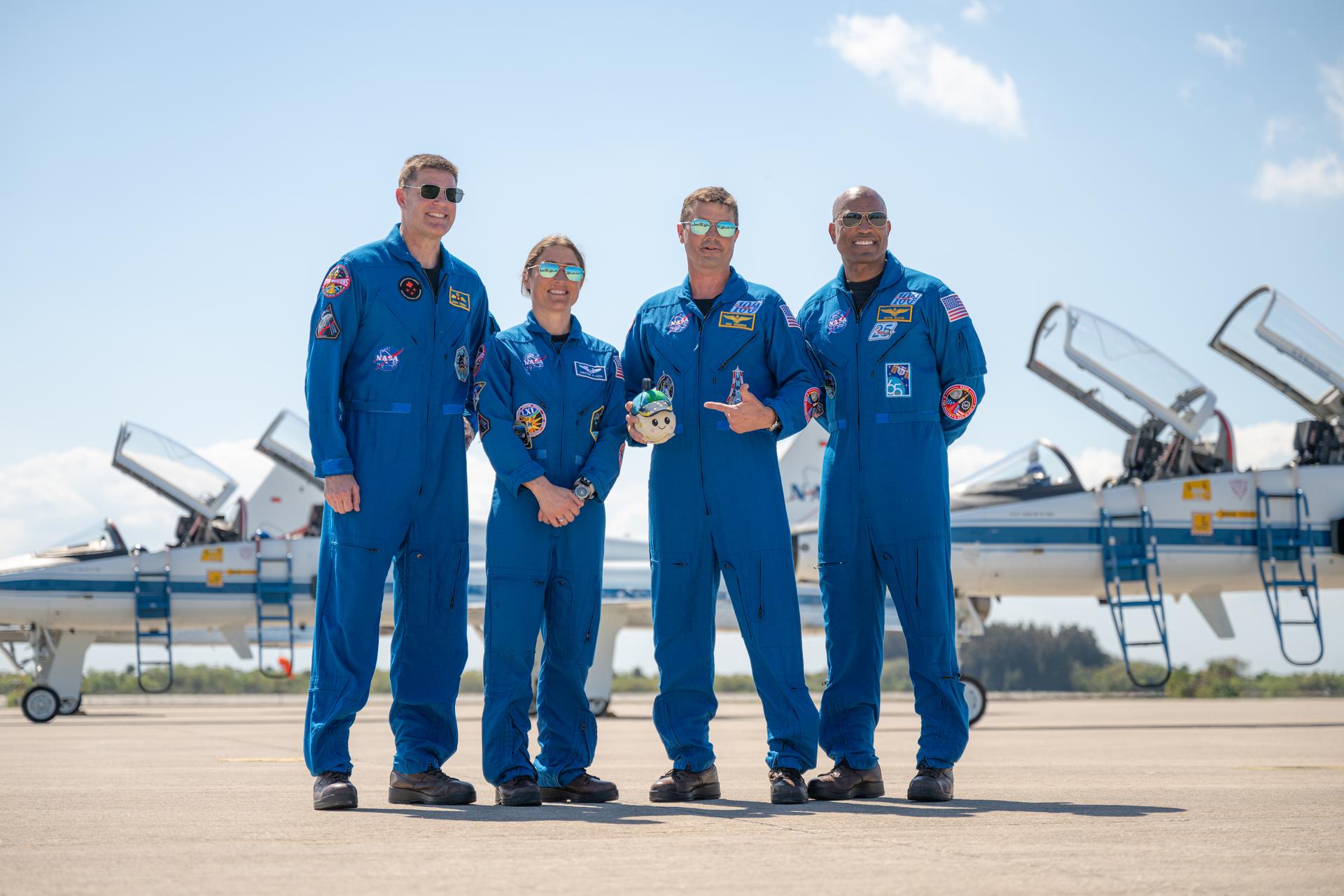 The Artemis II crew of CSA (Canadian Space Agency) astronaut Jeremy Hansen, Artemis II mission specialist; NASA astronaut Christina Koch, Artemis II mission specialist; NASA astronaut Reid Wiseman, Artemis II commander; and NASA astronaut Victor Glover, Artemis II pilot, pose for a photograph, Friday, March 27, 2026, after arriving at the Launch and Landing Facility at NASA’s Kennedy Space Center in Florida. The Artemis II mission will launch the crew on a 10-day journey around the Moon and back no earlier than April 1. Photo Credit: (NASA/John Kraus)