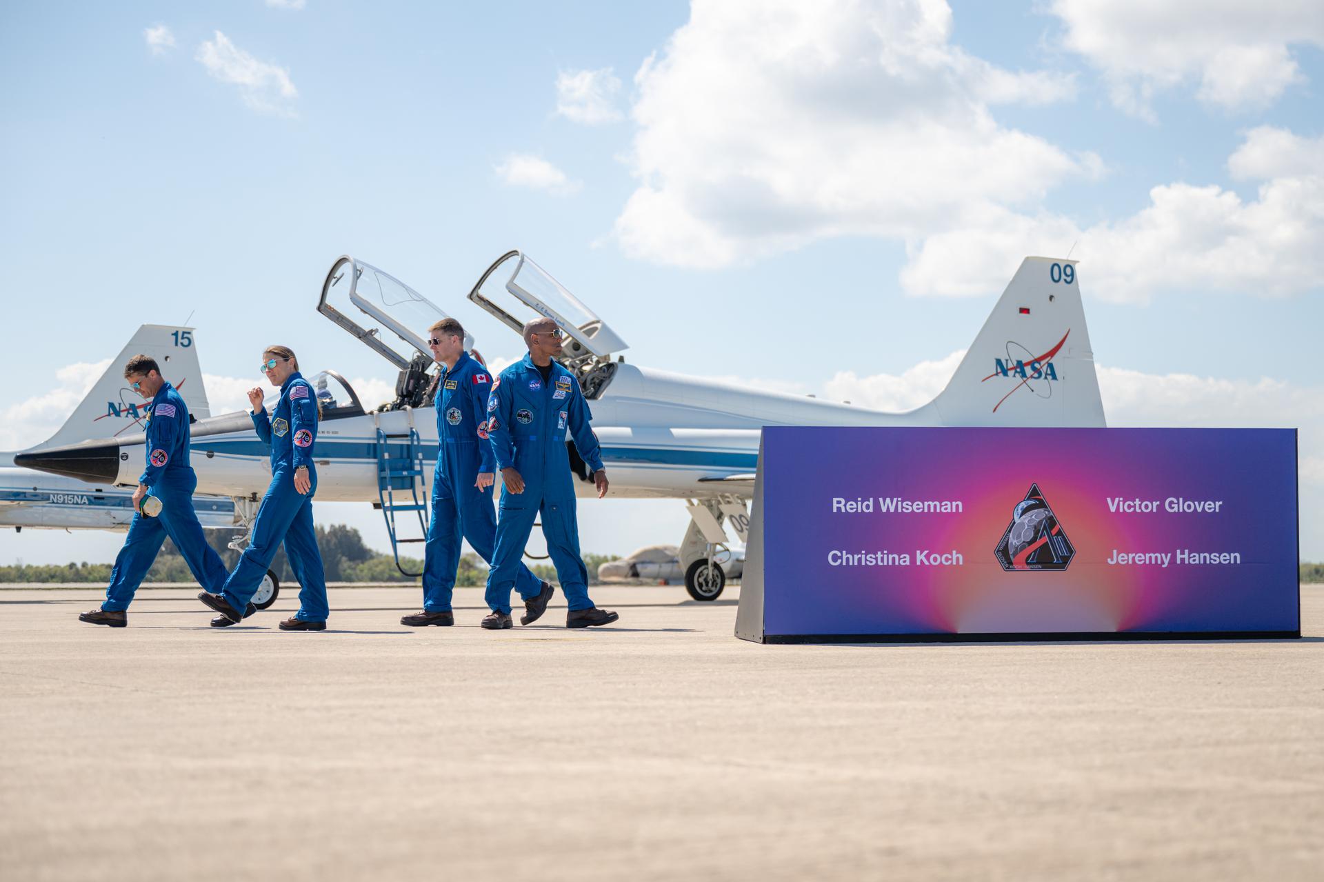 The Artemis II crew of NASA astronaut Reid Wiseman, Artemis II commander; NASA astronaut Christina Koch, Artemis II mission specialist; CSA (Canadian Space Agency) astronaut Jeremy Hansen, Artemis II mission specialist; and NASA astronaut Victor Glover, Artemis II pilot; are seen following a press conference, Friday, March 27, 2026, after arriving at the Launch and Landing Facility at NASA’s Kennedy Space Center in Florida. The Artemis II mission will launch the crew on a 10-day journey around the Moon and back no earlier than April 1. Photo Credit: (NASA/John Kraus)