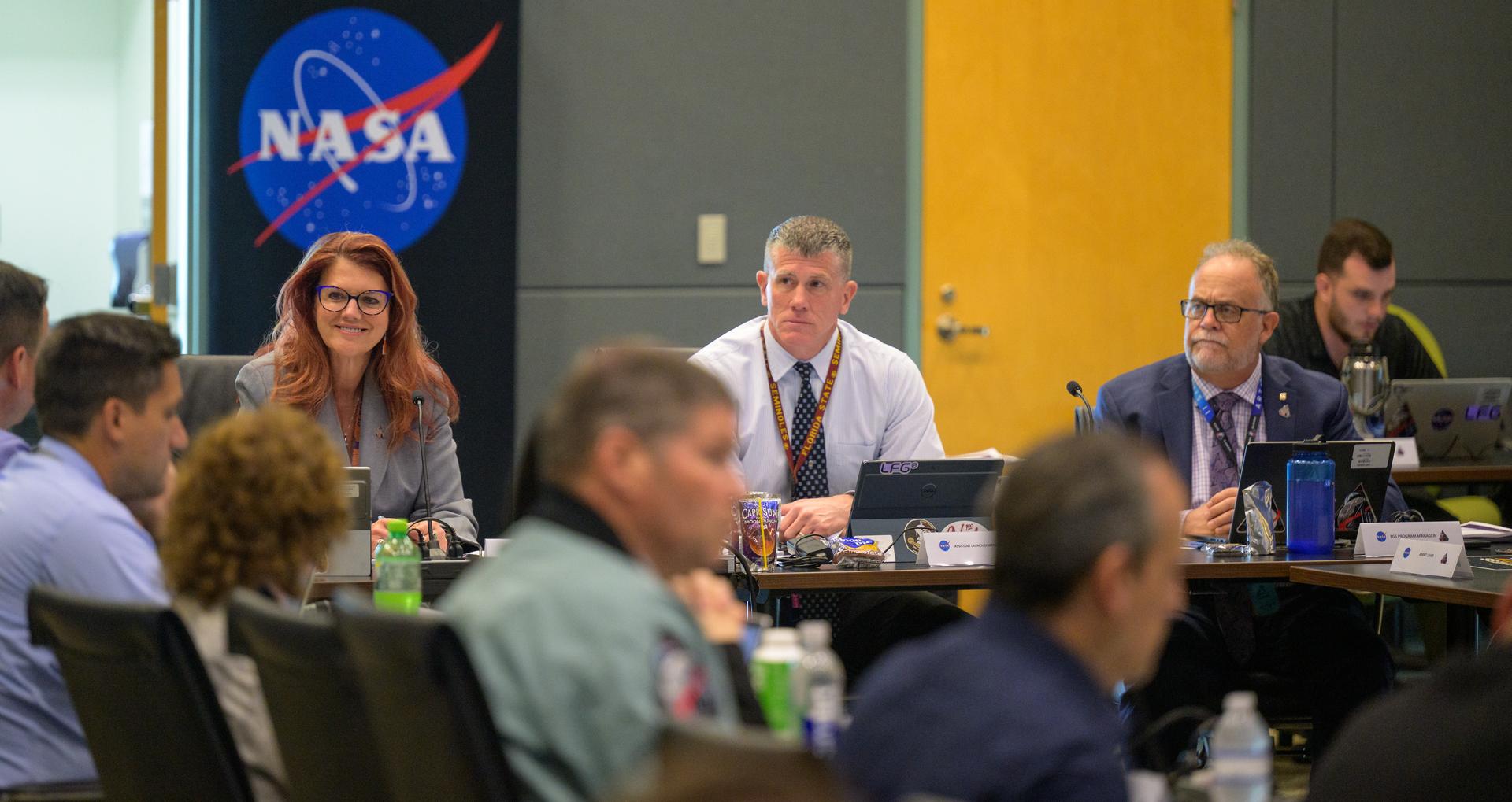 Charlie Blackwell-Thompson, Artemis II launch director, left, and Artemis II Assistant Launch Director Jeremy Graeber, and Shawn Quinn, manager of Exploration Ground Systems, right, are seen as teams meet for the Artemis II launch countdown pre-test briefing, Saturday, March 28, 2026, at NASA’s Kennedy Space Center, Operations Support Building II in Florida. Photo Credit: (NASA/Bill Ingalls)