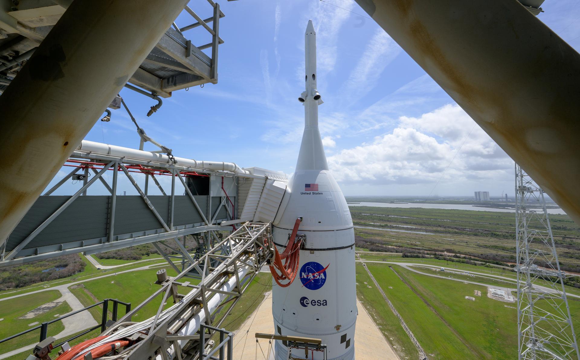 NASA’s Artemis II Space Launch System (SLS) rocket and Orion spacecraft are seen atop a mobile launcher at Launch Complex 39B, Monday, March 30, 2026, at NASA’s Kennedy Space Center in Florida. NASA’s Artemis II test flight will take Commander Reid Wiseman, Pilot Victor Glover, and Mission Specialist Christina Koch from NASA, and Mission Specialist Jeremy Hansen from the CSA (Canadian Space Agency), around the Moon and back to Earth with launch opportunities beginning in April 2026. Photo Credit: (NASA/Bill Ingalls)