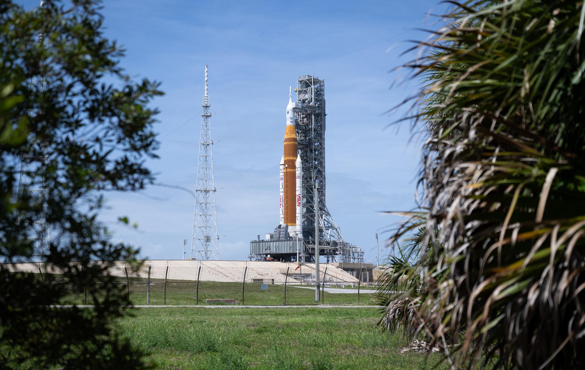 NASA’s Artemis II Space Launch System (SLS) rocket and Orion spacecraft are seen atop a mobile launcher at Launch Complex 39B, Monday, March 30, 2026, as preparations continue for launch at NASA’s Kennedy Space Center in Florida. NASA’s Artemis II test flight will take Commander Reid Wiseman, Pilot Victor Glover, and Mission Specialist Christina Koch from NASA, and Mission Specialist Jeremy Hansen from the CSA (Canadian Space Agency), around the Moon and back to Earth with launch opportunities beginning in April 2026. Photo Credit: (NASA/Joel Kowsky)