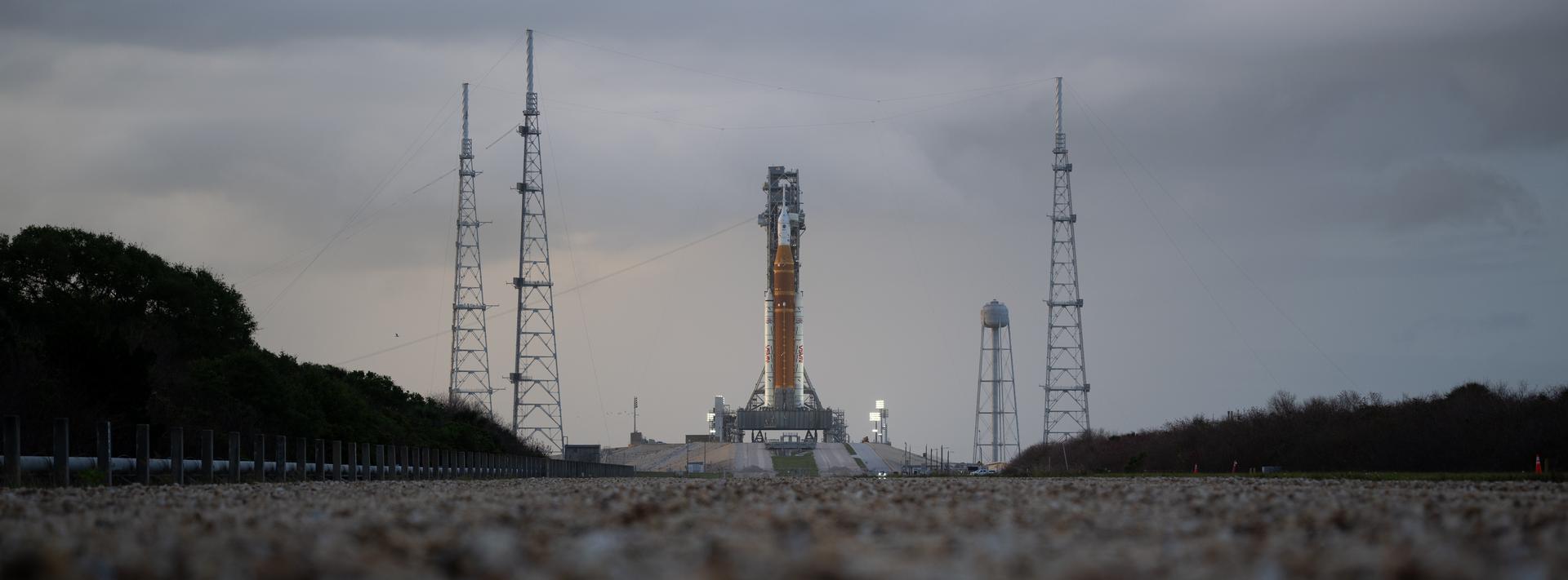NASA’s Artemis II Space Launch System (SLS) rocket and Orion spacecraft are seen atop a mobile launcher at Launch Complex 39B, Monday, March 30, 2026, as preparations continue for launch at NASA’s Kennedy Space Center in Florida. NASA’s Artemis II test flight will take Commander Reid Wiseman, Pilot Victor Glover, and Mission Specialist Christina Koch from NASA, and Mission Specialist Jeremy Hansen from the CSA (Canadian Space Agency), around the Moon and back to Earth with launch opportunities beginning in April 2026. Photo Credit: (NASA/Joel Kowsky)