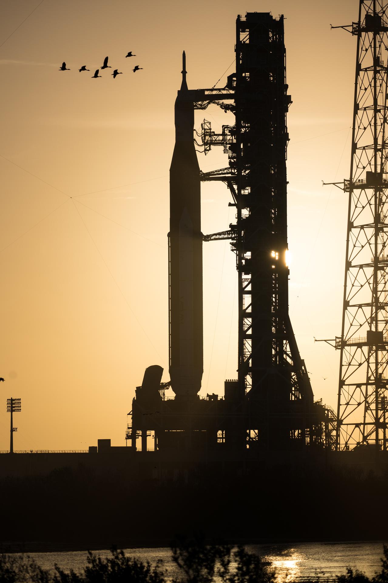 NASA’s Artemis II Space Launch System (SLS) rocket and Orion spacecraft are seen at sunset at Launch Complex 39B, Tuesday, March 31, 2026, at NASA’s Kennedy Space Center in Florida. The Artemis II test flight will take Commander Reid Wiseman, Pilot Victor Glover, and Mission Specialist Christina Koch from NASA, and Mission Specialist Jeremy Hansen from the CSA (Canadian Space Agency), around the Moon and back to Earth with launch opportunities beginning in April 2026. Photo Credit: (NASA/Aubrey Gemignani)