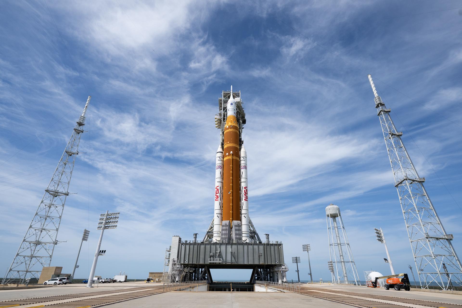 NASA’s Artemis II Space Launch System (SLS) rocket and Orion spacecraft is seen atop a mobile launcher at Launch Complex 39B, Tuesday, March 31, 2026, as preparations continue for launch at NASA’s Kennedy Space Center in Florida. NASA’s Artemis II test flight will take Commander Reid Wiseman, Pilot Victor Glover, and Mission Specialist Christina Koch from NASA, and Mission Specialist Jeremy Hansen from the CSA (Canadian Space Agency) on a 10-day journey around the Moon and back aboard SLS rocket and Orion spacecraft from Launch Complex 39B with launch targeted for no earlier than 6:24 p.m. EDT on Wednesday, April 1.  Photo Credit: (NASA/Joel Kowsky)