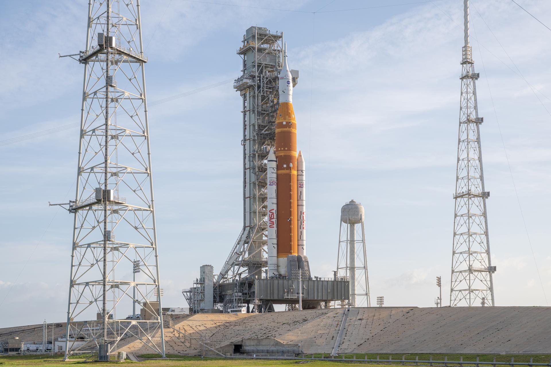 NASA’s Artemis II Space Launch System (SLS) rocket and Orion spacecraft are seen standing atop a mobile launcher at Launch Complex 39B, Tuesday, March 31, 2026, at NASA’s Kennedy Space Center in Florida. NASA’s Artemis II test flight will take Commander Reid Wiseman, Pilot Victor Glover, and Mission Specialist Christina Koch from NASA, and Mission Specialist Jeremy Hansen from the CSA (Canadian Space Agency), around the Moon and back to Earth no earlier than April 1, 2026. Photo Credit: (NASA/John Kraus)