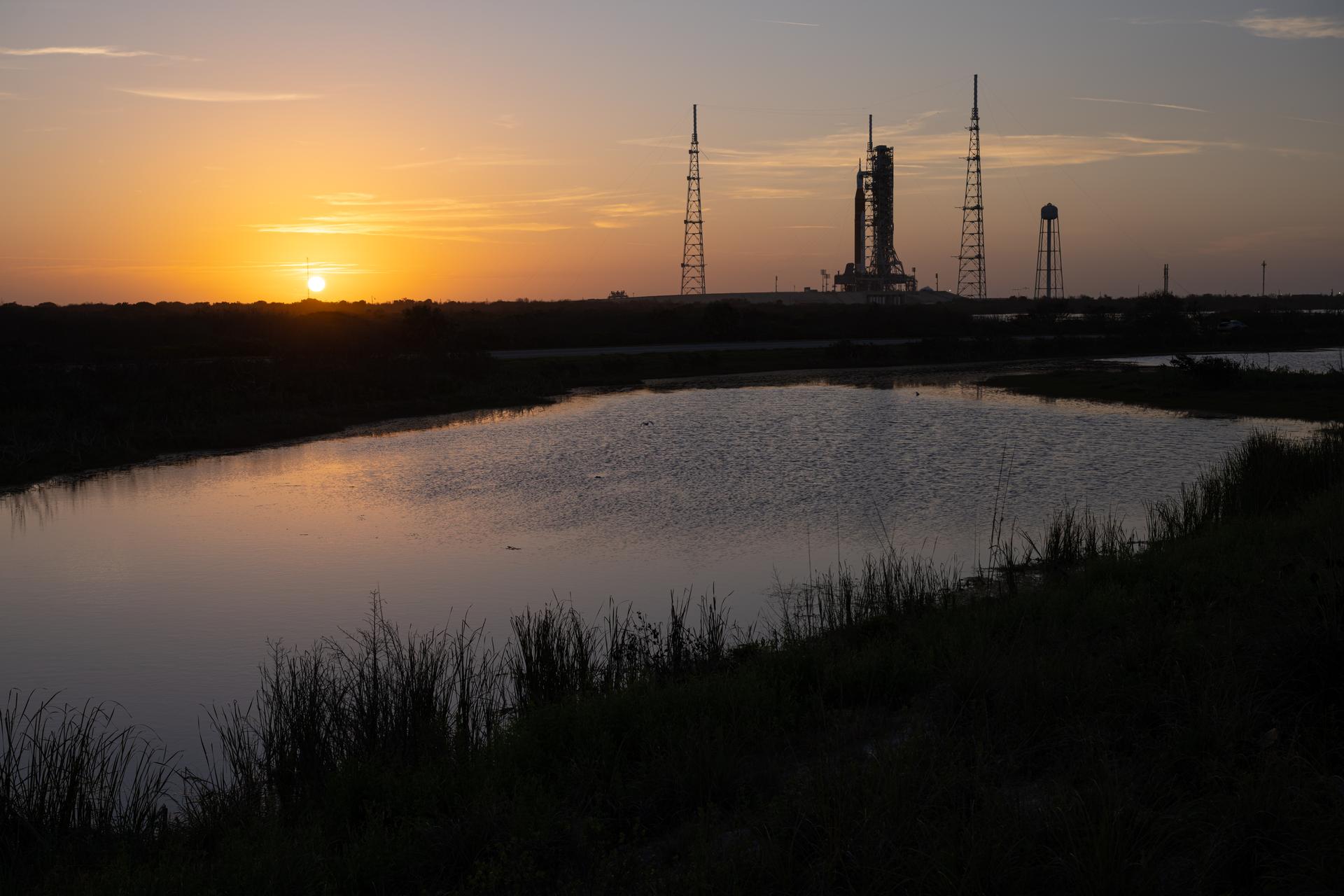 NASA’s Artemis II Space Launch System (SLS) rocket and Orion spacecraft are seen standing atop a mobile launcher at Launch Complex 39B, Tuesday, March 31, 2026, at NASA’s Kennedy Space Center in Florida. NASA’s Artemis II test flight will take Commander Reid Wiseman, Pilot Victor Glover, and Mission Specialist Christina Koch from NASA, and Mission Specialist Jeremy Hansen from the CSA (Canadian Space Agency), around the Moon and back to Earth no earlier than April 1, 2026. Photo Credit: (NASA/John Kraus)