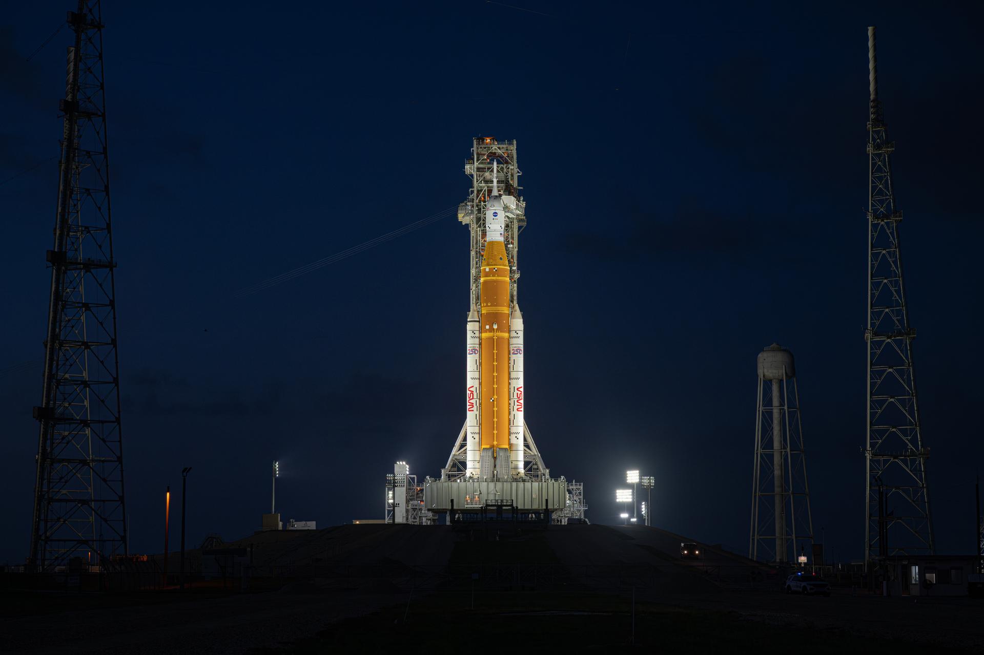 NASA’s Artemis II Space Launch System (SLS) rocket and Orion spacecraft are seen standing atop a mobile launcher at Launch Complex 39B, Tuesday, March 31, 2026, at NASA’s Kennedy Space Center in Florida. NASA’s Artemis II test flight will take Commander Reid Wiseman, Pilot Victor Glover, and Mission Specialist Christina Koch from NASA, and Mission Specialist Jeremy Hansen from the CSA (Canadian Space Agency), around the Moon and back to Earth no earlier than April 1, 2026. Photo Credit: (NASA/John Kraus)