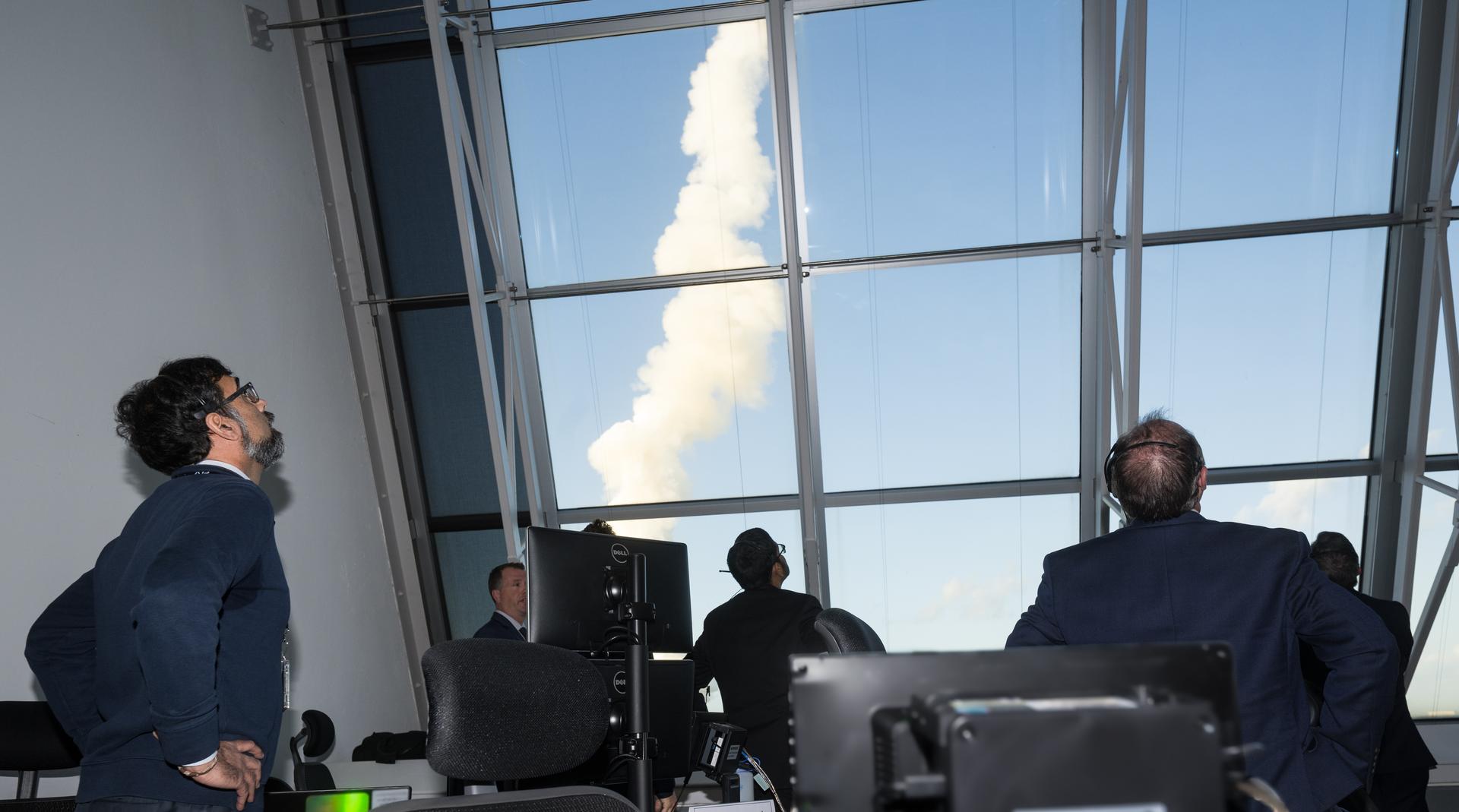 From left to right, NASA Associate Administrator Amit Kshatriya, NASA Chief Engineer Joseph Pellicciotti, and others watch the launch of NASA’s Space Launch System (SLS) rocket and Orion spacecraft with NASA astronauts Reid Wiseman, commander; Victor Glover, pilot; Christina Koch, mission specialist; and CSA (Canadian Space Agency) astronaut Jeremy Hansen, mission specialist onboard on the Artemis II mission from Firing Room 2 of the Rocco A. Petrone Launch Control Center, Wednesday, April 1, 2026, at NASA’s Kennedy Space Center in Florida. NASA’s Artemis II mission will take Wiseman, Glover, Koch, and Hansen on a 10-day journey around the Moon and back aboard SLS rocket and Orion spacecraft from Launch Complex 39B. The quartet launched at 6:35pm EDT. Photo Credit: (NASA/Aubrey Gemignani) NOTE - Portions of this image have been blurred for security reasons.