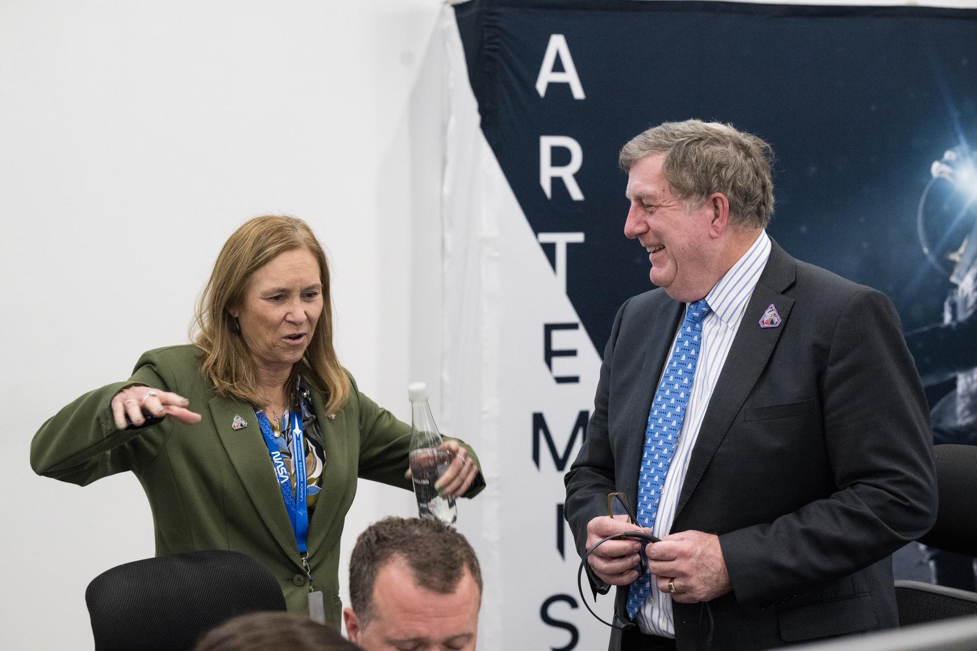 Director of NASA's Kennedy Space Center, Janet Petro, left, and Lockheed Martin Vice President of the Lunar Exploration Campaign, Kirk Shireman, speak after watching the launch of NASA’s Space Launch System (SLS) rocket and Orion spacecraft with NASA astronauts Reid Wiseman, commander; Victor Glover, pilot; Christina Koch, mission specialist; and CSA (Canadian Space Agency) astronaut Jeremy Hansen, mission specialist onboard on the Artemis II mission in Firing Room 2 of the Rocco A. Petrone Launch Control Center, Wednesday, April 1, 2026, at NASA’s Kennedy Space Center in Florida. NASA’s Artemis II mission will take Wiseman, Glover, Koch, and Hansen on a 10-day journey around the Moon and back aboard SLS rocket and Orion spacecraft from Launch Complex 39B. The quartet launched at 6:35pm EDT. Photo Credit: (NASA/Aubrey Gemignani) NOTE - Portions of this image have been blurred for security reasons.