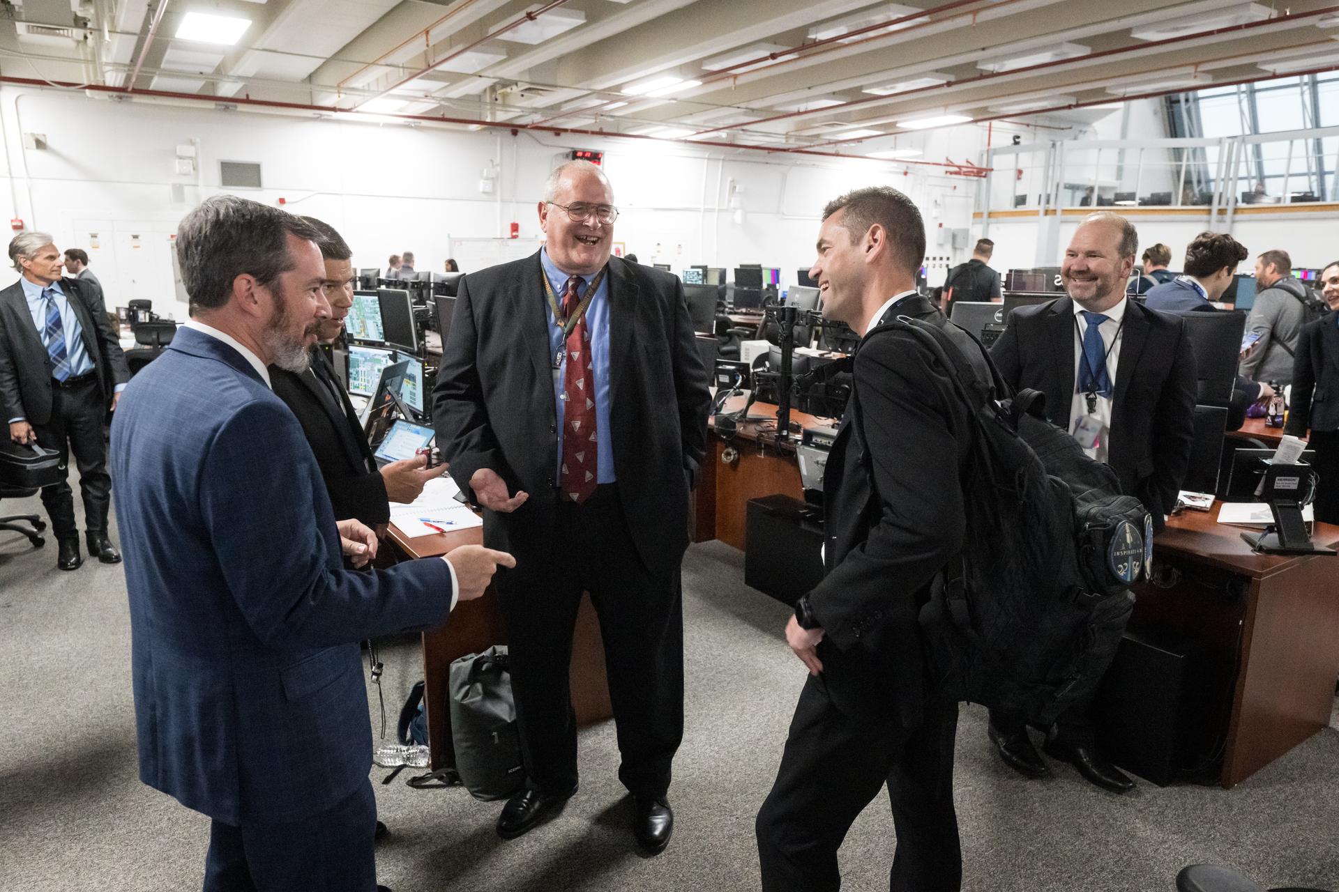 NASA Administrator Jared Isaacman, right, congratulates Artemis II mission team members after the launch of NASA’s Space Launch System (SLS) rocket and Orion spacecraft with NASA astronauts Reid Wiseman, commander; Victor Glover, pilot; Christina Koch, mission specialist; and CSA (Canadian Space Agency) astronaut Jeremy Hansen, mission specialist onboard in Firing Room 2 of the Rocco A. Petrone Launch Control Center, Wednesday, April 1, 2026, at NASA’s Kennedy Space Center in Florida. NASA’s Artemis II mission will take Wiseman, Glover, Koch, and Hansen on a 10-day journey around the Moon and back aboard the SLS rocket and Orion spacecraft from Launch Complex 39B. The quartet launched at 6:35pm EDT. Photo Credit: (NASA/Aubrey Gemignani) NOTE - Portions of this image have been blurred for security reasons.
