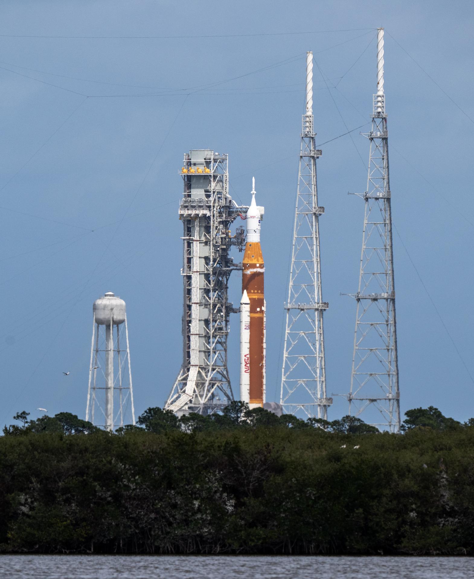 NASA’s Space Launch System (SLS) rocket with the Orion spacecraft aboard is seen atop the mobile launcher at Launch Complex 39B, Wednesday, April 1, 2026, as the launch countdown progresses at NASA’s Kennedy Space Center in Florida. NASA’s Artemis II mission will take NASA astronauts Reid Wiseman, commander; Victor Glover, pilot; Christina Koch, mission specialist; and CSA (Canadian Space Agency) astronaut Jeremy Hansen, mission specialist on a 10-day journey around the Moon and back aboard SLS rocket and Orion spacecraft from Launch Complex 39B, with a two hour launch window opening at 6:24 p.m. EDT.  Photo Credit: (NASA/Keegan Barber)