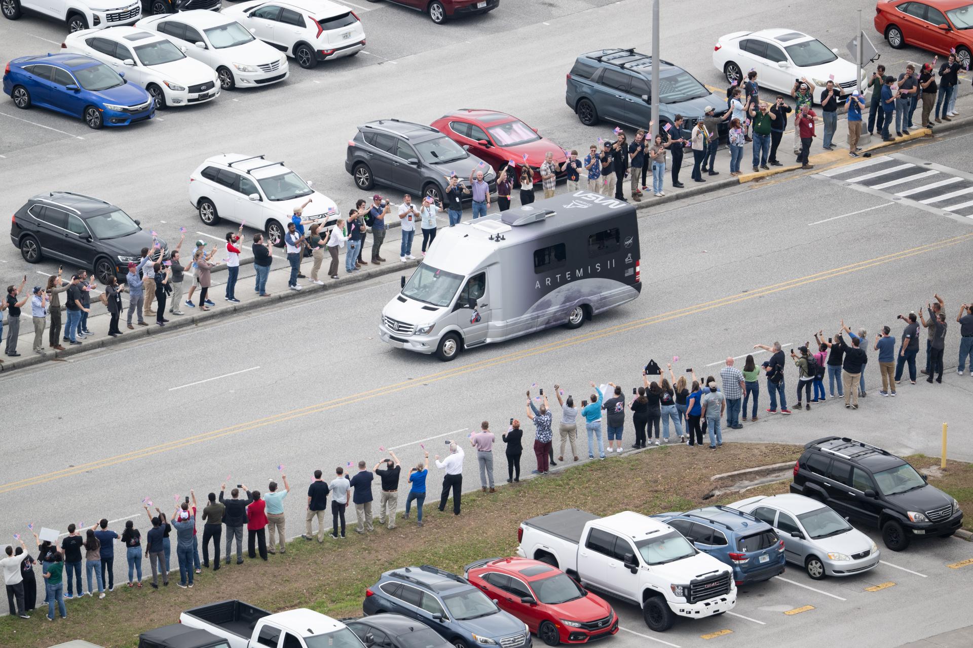 The astrovan with NASA astronauts Reid Wiseman, commander; Victor Glover, pilot; Christina Koch, mission specialist; and CSA (Canadian Space Agency) astronaut Jeremy Hansen, mission specialist, drives by the Vehicle Assembly Building towards Launch Complex 39B ahead of the crew boarding their Orion spacecraft atop NASA’s Space Launch System (SLS) rocket, Wednesday, April 1, 2026, at NASA’s Kennedy Space Center in Florida. NASA’s Artemis II mission will take Wiseman, Glover, Koch, and Hansen on a 10-day journey around the Moon and back aboard SLS rocket and Orion spacecraft from Launch Complex 39B, with a two hour launch window opening at 6:24 p.m. EDT.  Photo Credit: (NASA/Joel Kowsky)