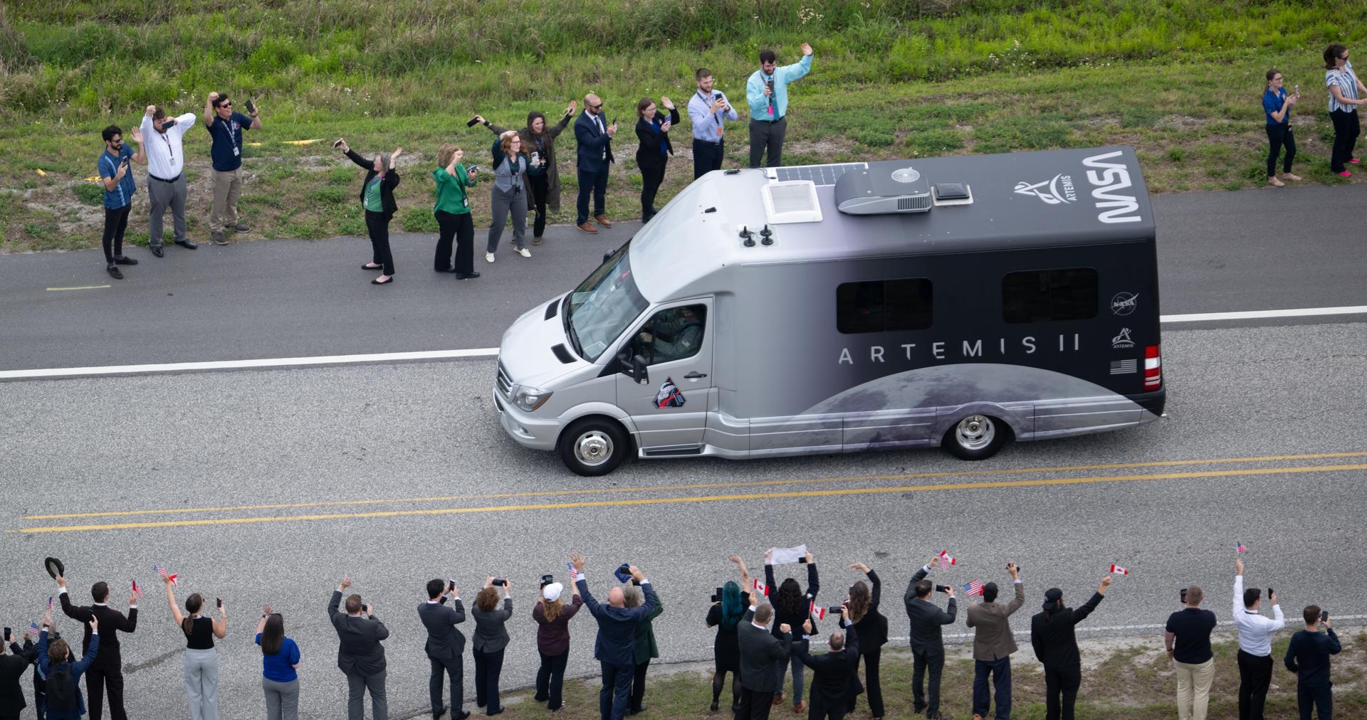 The astrovan with NASA astronauts Reid Wiseman, commander; Victor Glover, pilot; Christina Koch, mission specialist; and CSA (Canadian Space Agency) astronaut Jeremy Hansen, mission specialist, drives by the Vehicle Assembly Building towards Launch Complex 39B ahead of the crew boarding their Orion spacecraft atop NASA’s Space Launch System (SLS) rocket, Wednesday, April 1, 2026, at NASA’s Kennedy Space Center in Florida. NASA’s Artemis II mission will take Wiseman, Glover, Koch, and Hansen on a 10-day journey around the Moon and back aboard SLS rocket and Orion spacecraft from Launch Complex 39B, with a two hour launch window opening at 6:24 p.m. EDT.  Photo Credit: (NASA/Joel Kowsky)