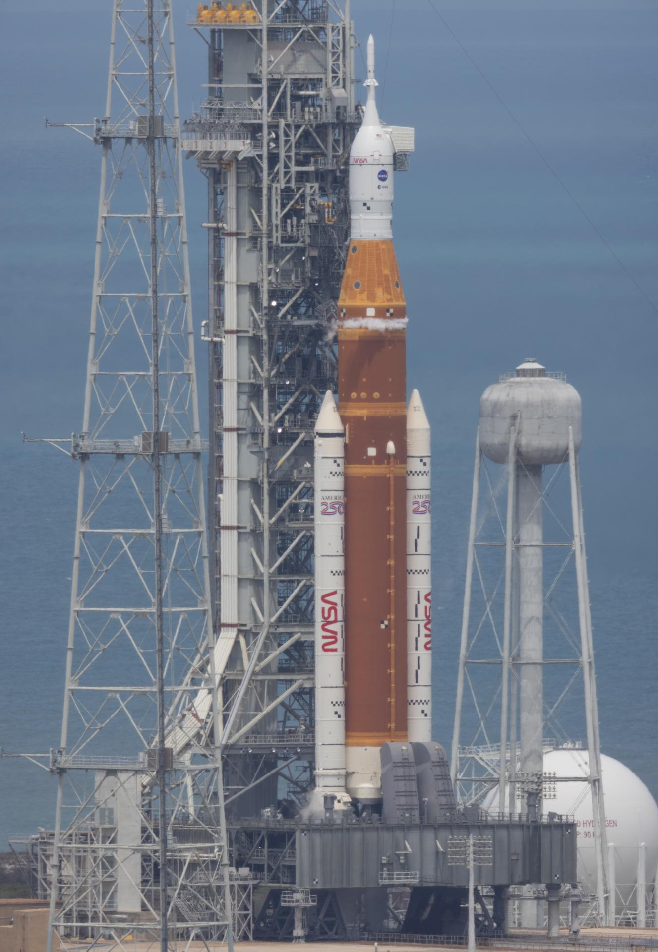 NASA’s Space Launch System (SLS) rocket with the Orion spacecraft aboard is seen atop the mobile launcher after the arrival of NASA astronauts Reid Wiseman, commander; Victor Glover, pilot; Christina Koch, mission specialist; and CSA (Canadian Space Agency) astronaut Jeremy Hansen, mission specialist at Launch Complex 39B, Wednesday, April 1, 2026, as the launch countdown progresses at NASA’s Kennedy Space Center in Florida. NASA’s Artemis II mission will take Wiseman, Glover, Koch, and Hansen on a 10-day journey around the Moon and back aboard SLS rocket and Orion spacecraft from Launch Complex 39B, with a two hour launch window opening at 6:24 p.m. EDT.  Photo Credit: (NASA/Joel Kowsky)