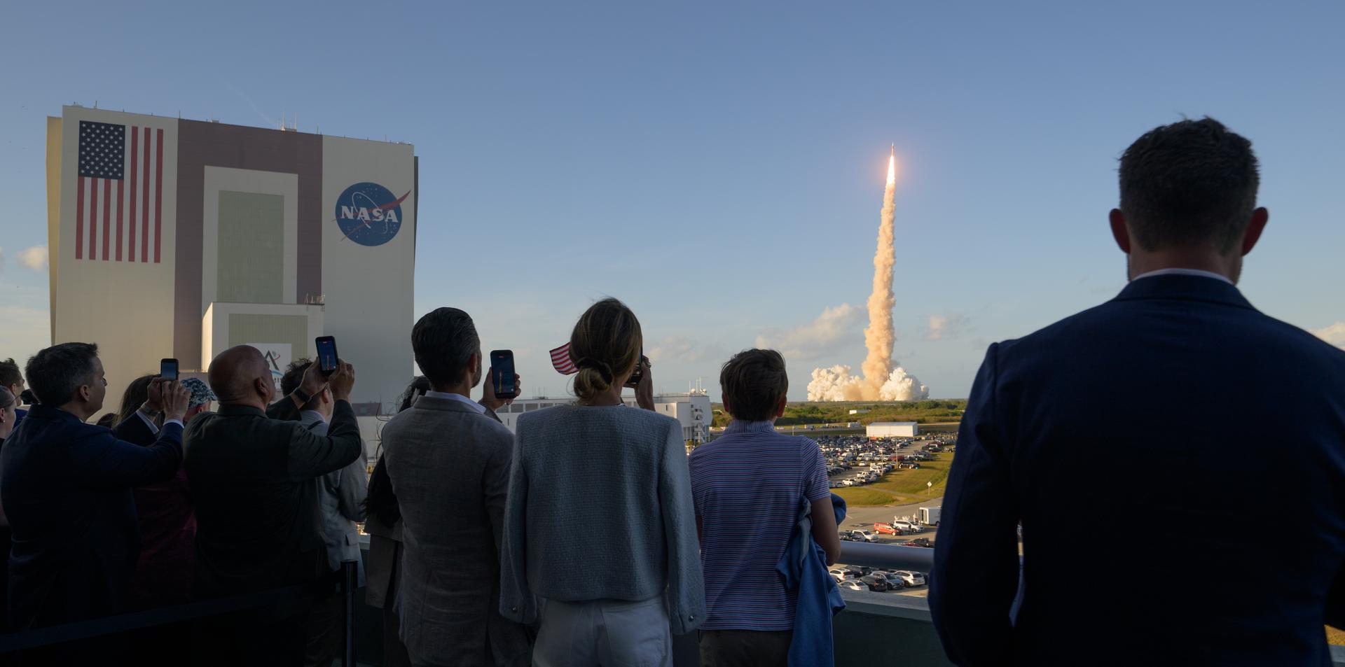 Employees and invited guest, including Eric Trump family, left, and Donald Trump Jr. family, right, watch the launch of NASA’s Space Launch System rocket carrying the Orion spacecraft with NASA astronauts Reid Wiseman, commander; Victor Glover, pilot; Christina Koch, mission specialist; and CSA (Canadian Space Agency) astronaut Jeremy Hansen, mission specialist on NASA’s Artemis II mission,, Wednesday, April 1, 2026, from Operations and Support Building II at NASA’s Kennedy Space Center in Florida. NASA’s Artemis II mission will take Wiseman, Glover, Koch, and Hansen on a 10-day journey around the Moon and back aboard SLS rocket and Orion spacecraft launched at 6:35pm EDT from Launch Complex 39B. Photo Credit: (NASA/Bill Ingalls)